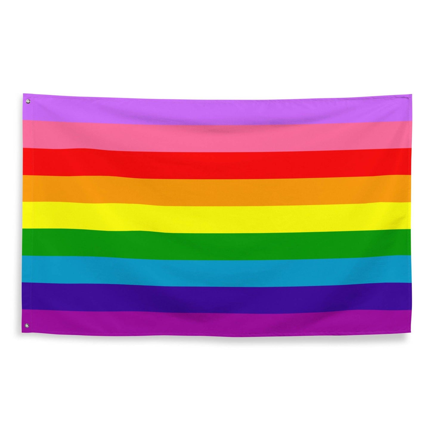 The Gilbert Baker Pride Flag from Pridelity, featuring vibrant horizontal stripes in red, orange, yellow, green, blue, and purple, elegantly adorns a white brick wall.