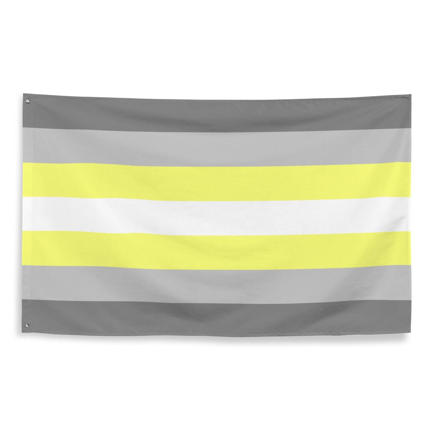 A Demigender Pride Flag from Pridelity, featuring horizontal stripes in gray, yellow, white, light yellow, and gray, adorns the textured white brick wall backdrop of a rainbow shop.