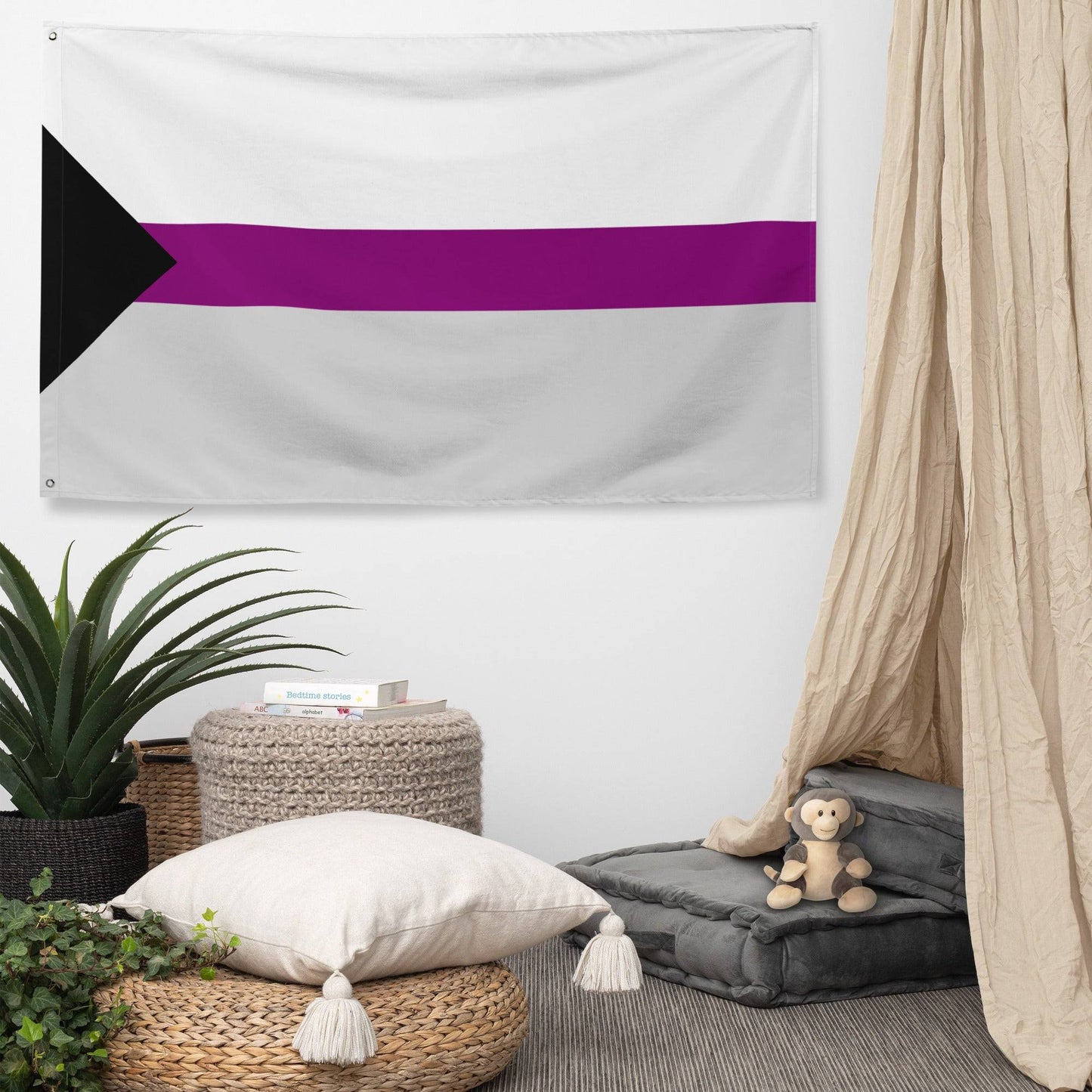 The Demisexual Pride Flag from Pridelity features a design with a black triangle on the left, white stripes, a wide purple band in the center, followed by another white stripe. It is beautifully displayed against a white brick wall.