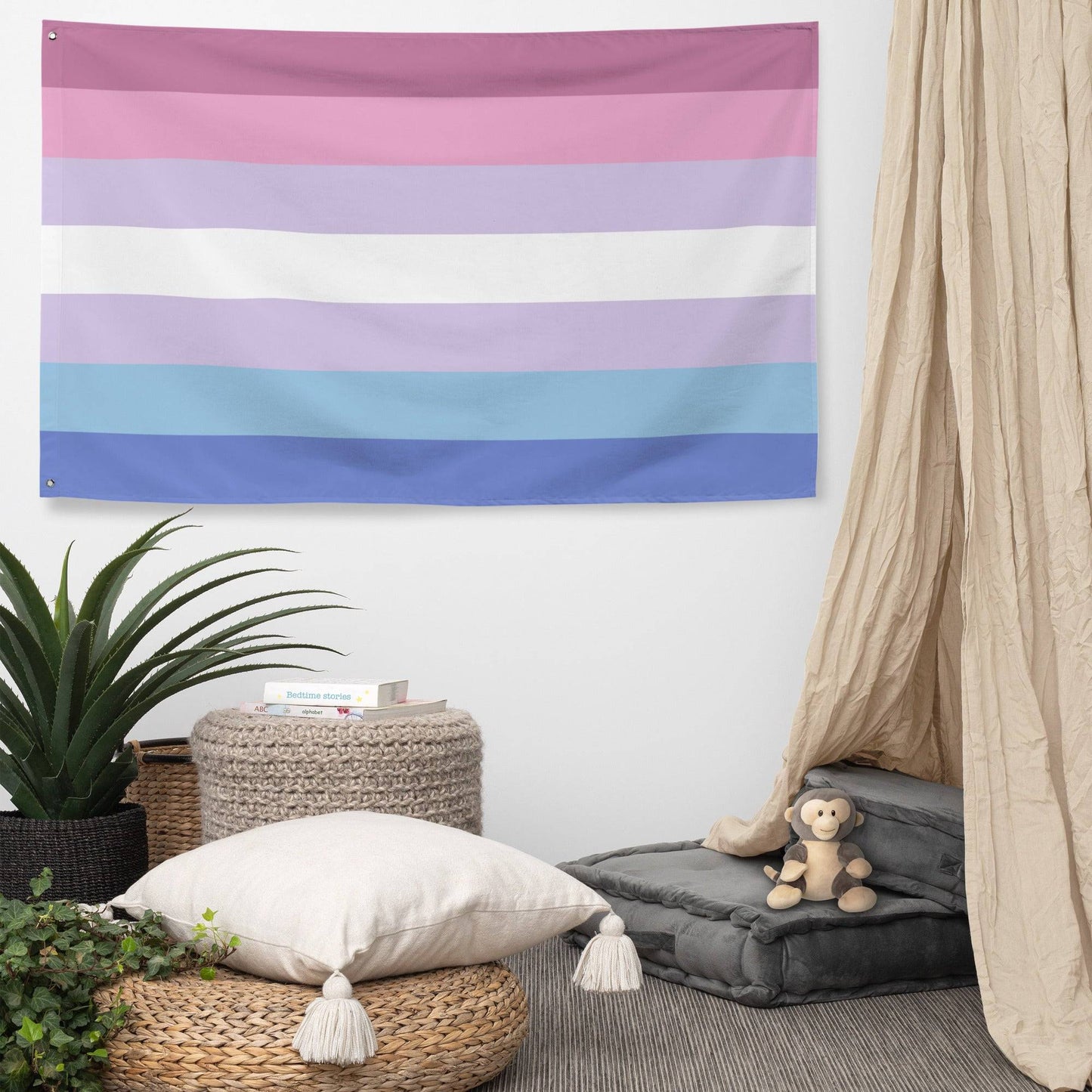 A Pridelity Bigender Pride Flag, featuring horizontal stripes in shades of pink, white, and blue, hangs proudly against a white brick wall.