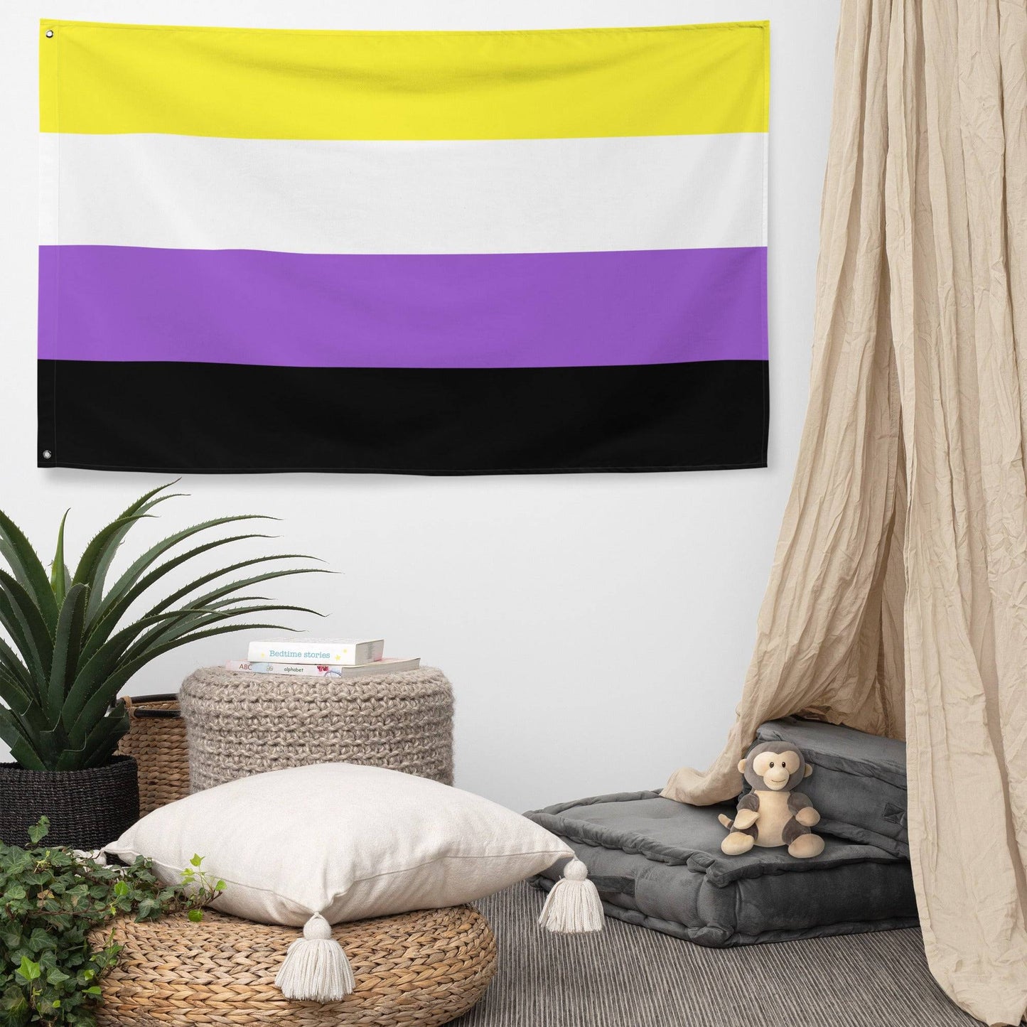 A vibrant Nonbinary Pride Flag from Pridelity, featuring horizontal stripes in yellow, white, purple, and black, hangs proudly on a white brick wall at the entrance of the rainbow shop.