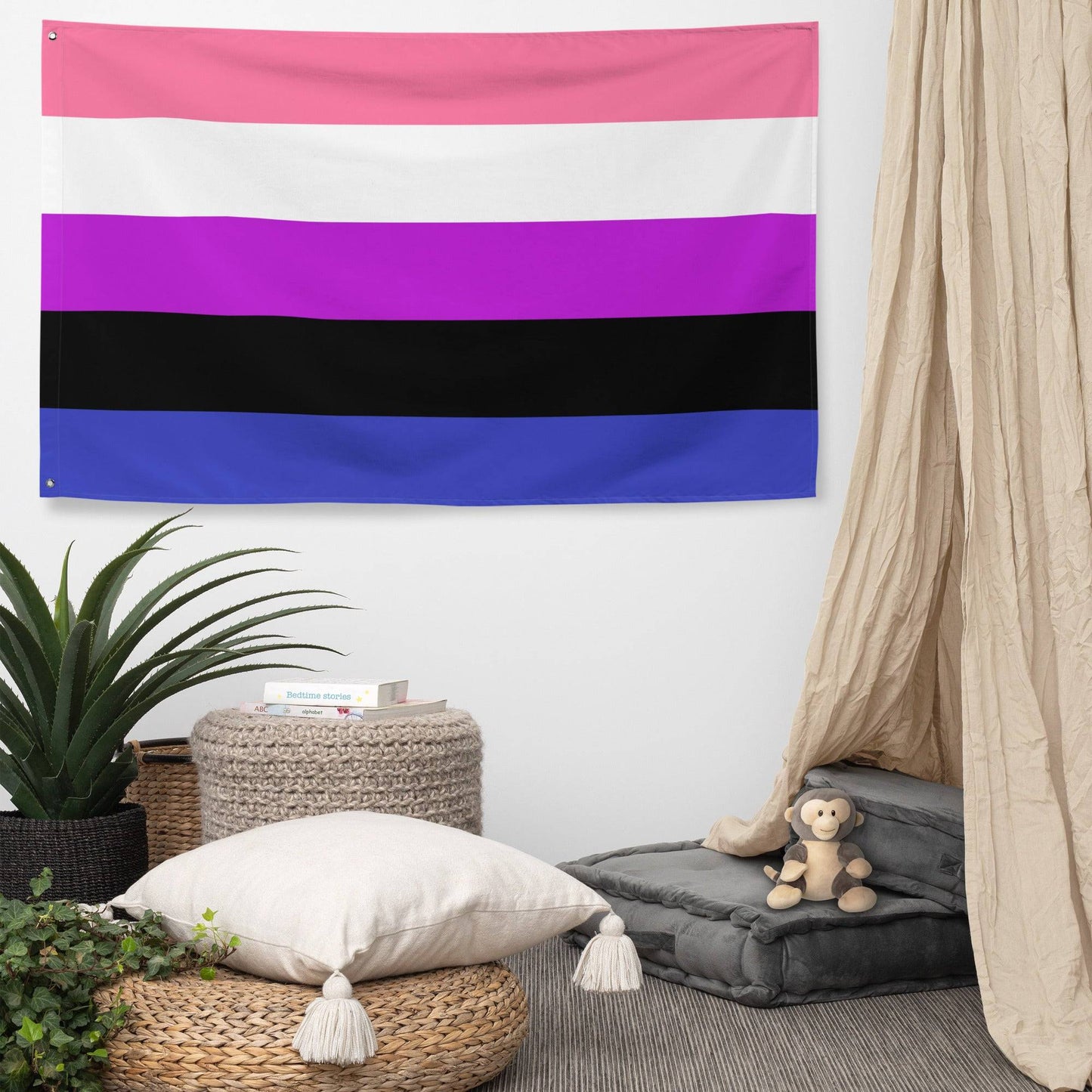 The image showcases a lively scene of the Pridelity Genderfluid Pride Flag displayed on a white brick wall, resembling a colorful shop exhibit. The flag has five horizontal stripes in pink, white, purple, black, and blue.