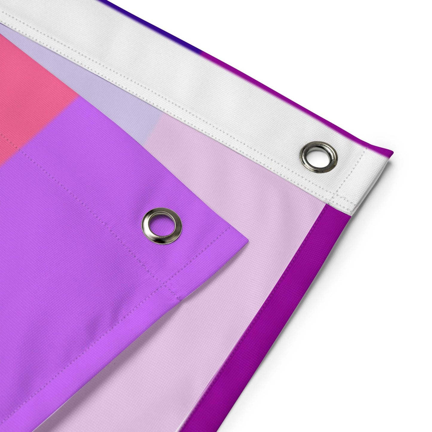 The Gilbert Baker Pride Flag from Pridelity, featuring vibrant horizontal stripes in red, orange, yellow, green, blue, and purple, elegantly adorns a white brick wall.