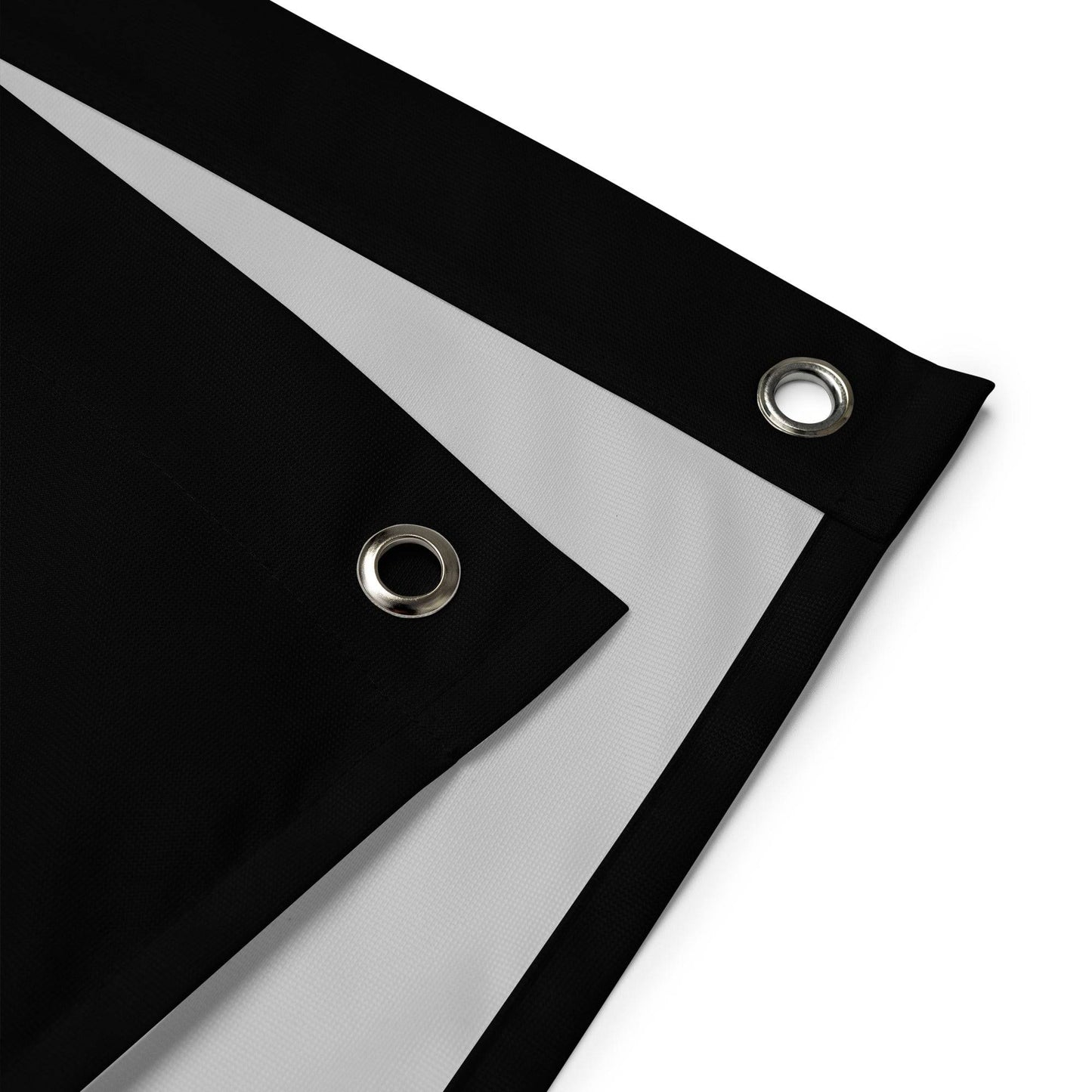 A "Peace Flag" by Pridelity, showcasing a vibrant peace symbol on a black background, hangs against a white brick wall.