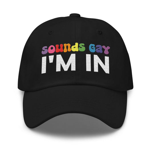 Introducing the "Sounds Gay I'm In Cap" by Pridelity, a black baseball cap ideal for pride outfits. It showcases the vibrant phrase "Sounds Gay" in contrast to the striking white "I'm In," making it a standout accessory for any celebration.