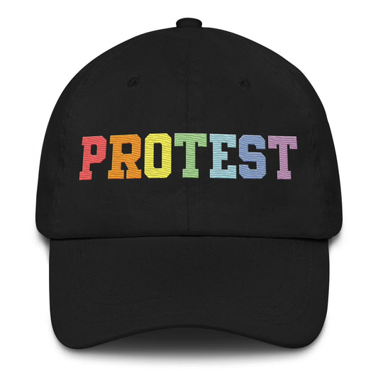 Introducing the Pridelity Protest Cap: A sleek black baseball cap with "PROTEST" intricately embroidered in vibrant rainbow colors on the front, making it an ideal addition to your pride ensemble.