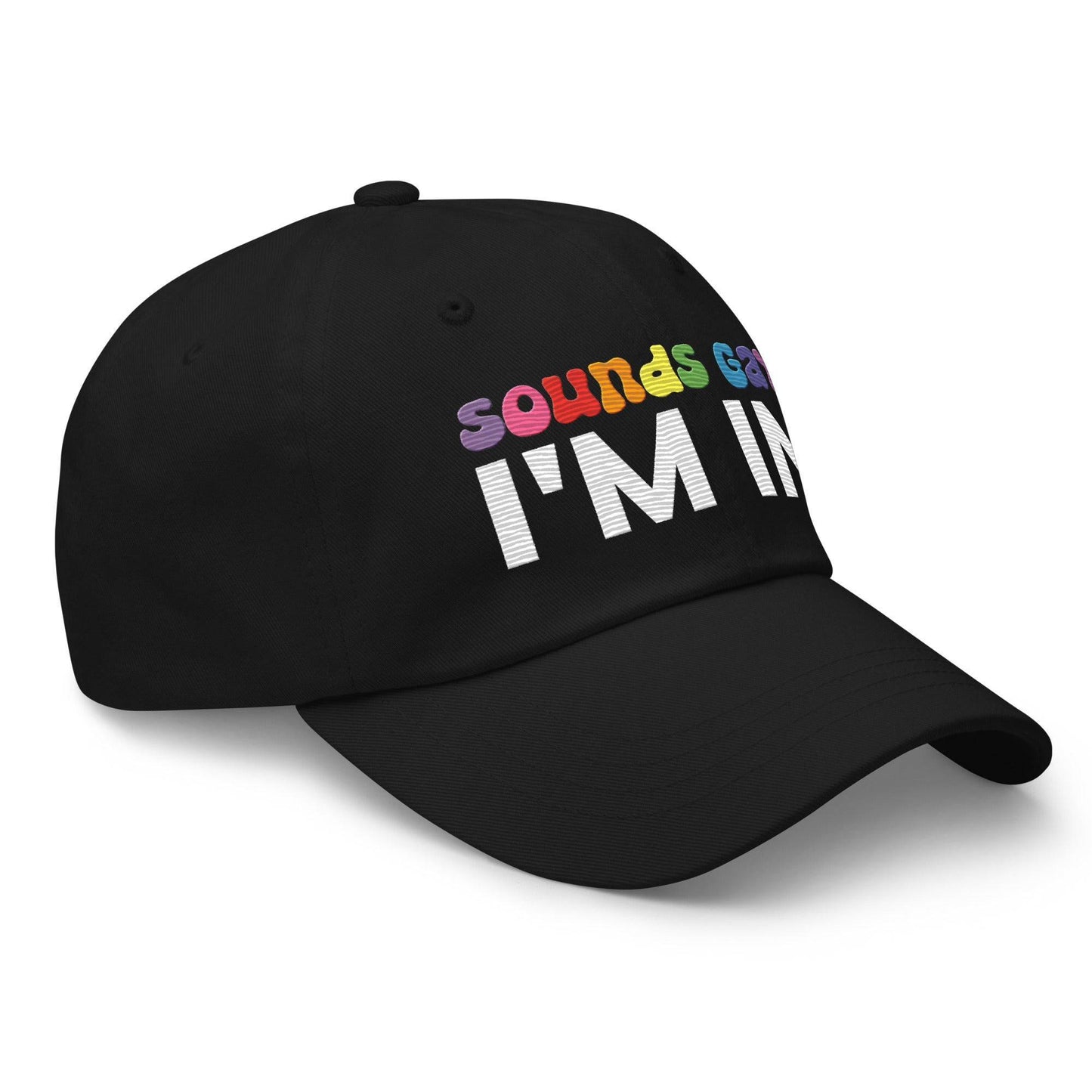 Introducing the "Sounds Gay I'm In Cap" by Pridelity, a black baseball cap ideal for pride outfits. It showcases the vibrant phrase "Sounds Gay" in contrast to the striking white "I'm In," making it a standout accessory for any celebration.