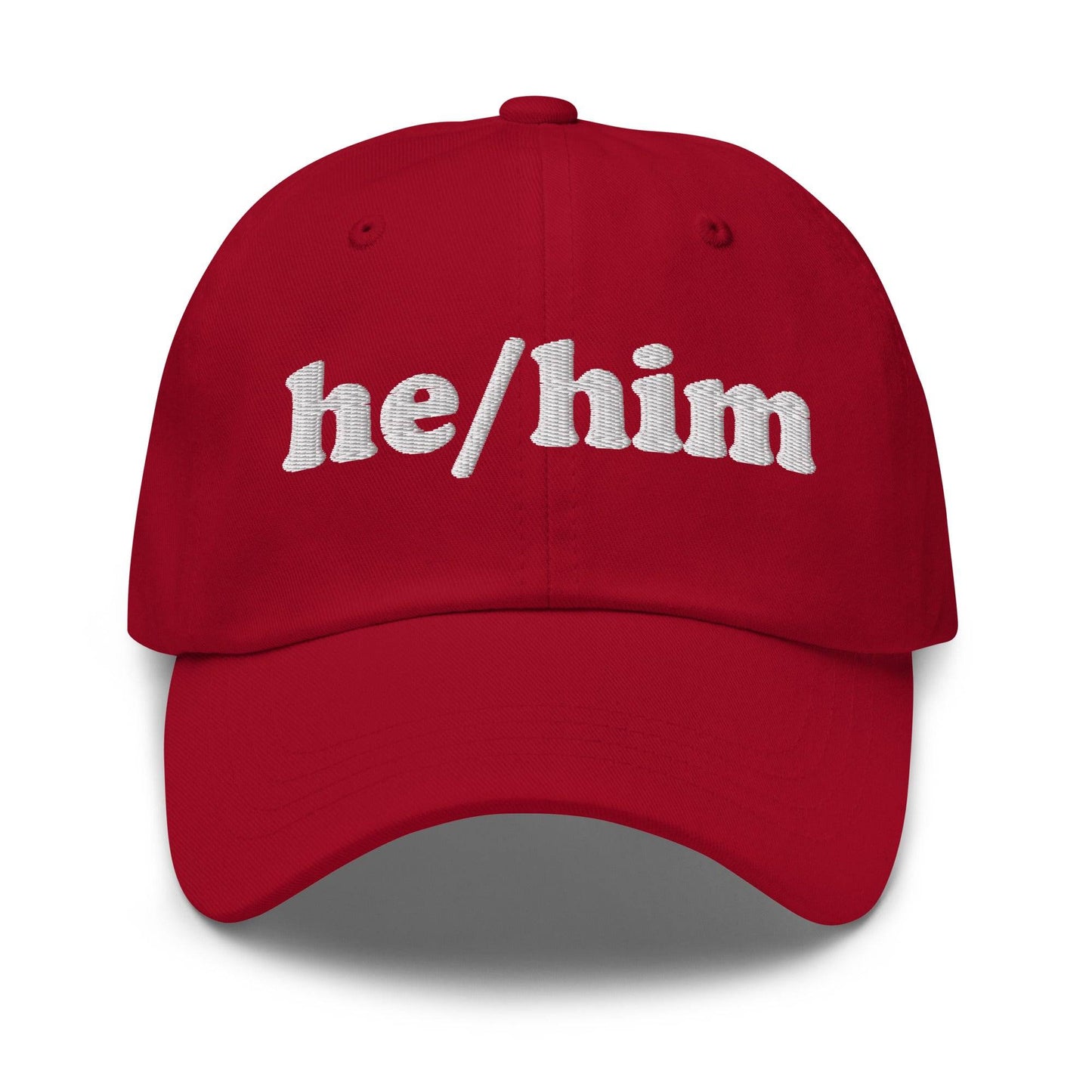 Introducing the He/Him Cap by Pridelity: A stylish black cap featuring "he/him" embroidered in white on the front. It adds a subtle yet meaningful touch to pride outfits while celebrating identity with simplicity and elegance.