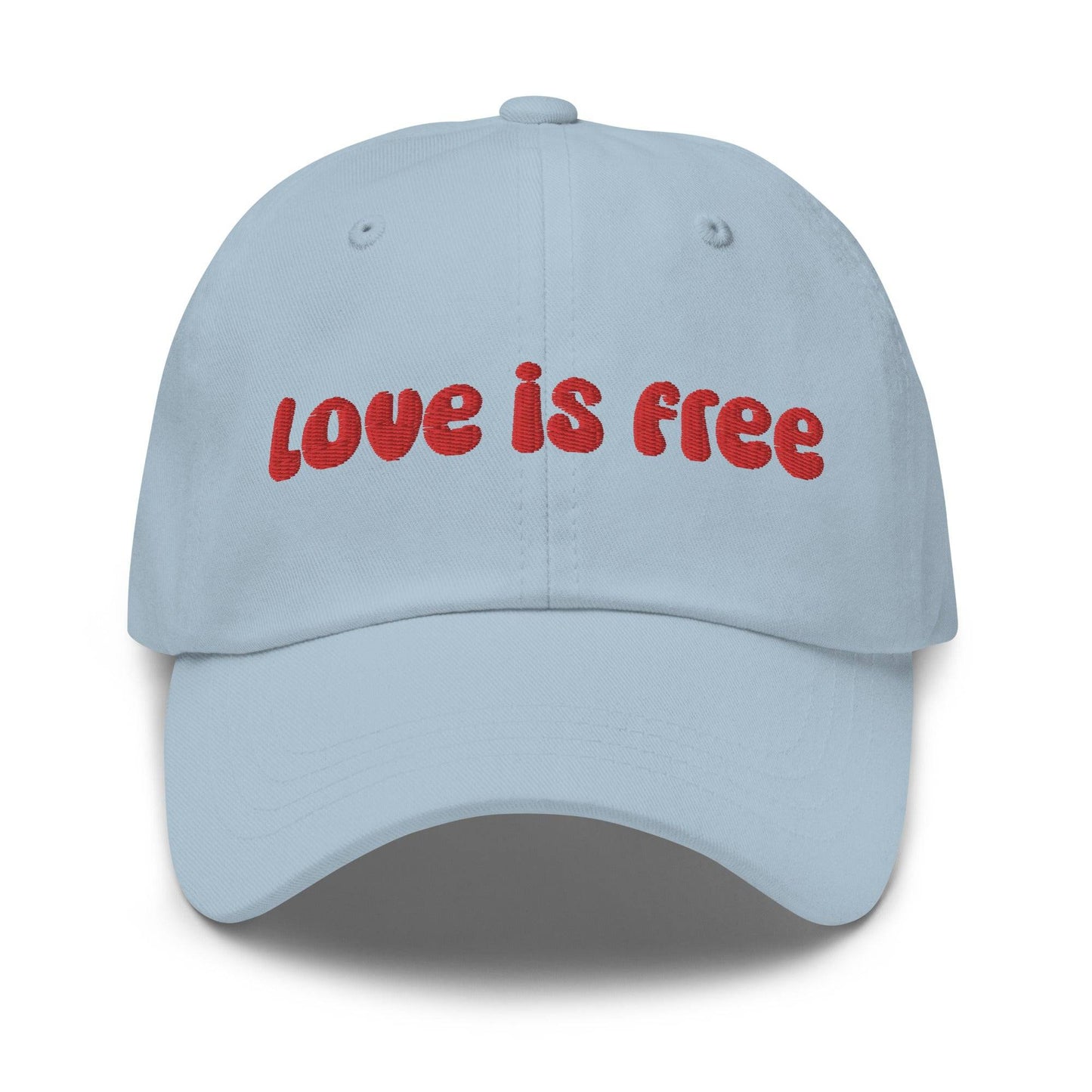 The Pridelity Love Is Free Cap, in a striking white color, is an ideal addition to pride outfits. It boasts the phrase "love is free" beautifully embroidered in bold red lettering on the front.