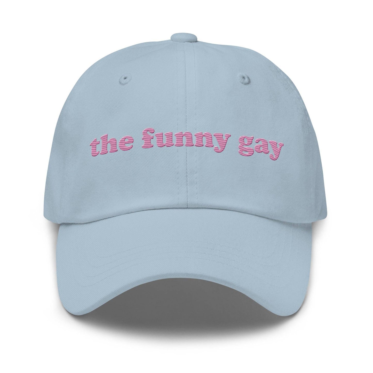 Introducing "The Funny Gay Cap" by Pridelity, a white cap featuring pink embroidered text that reads "the funny gay," ideal for adding a playful flair to your pride ensembles.