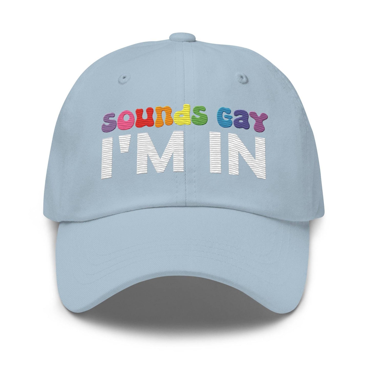 Introducing the "Sounds Gay I'm In Cap" by Pridelity, a black baseball cap ideal for pride outfits. It showcases the vibrant phrase "Sounds Gay" in contrast to the striking white "I'm In," making it a standout accessory for any celebration.