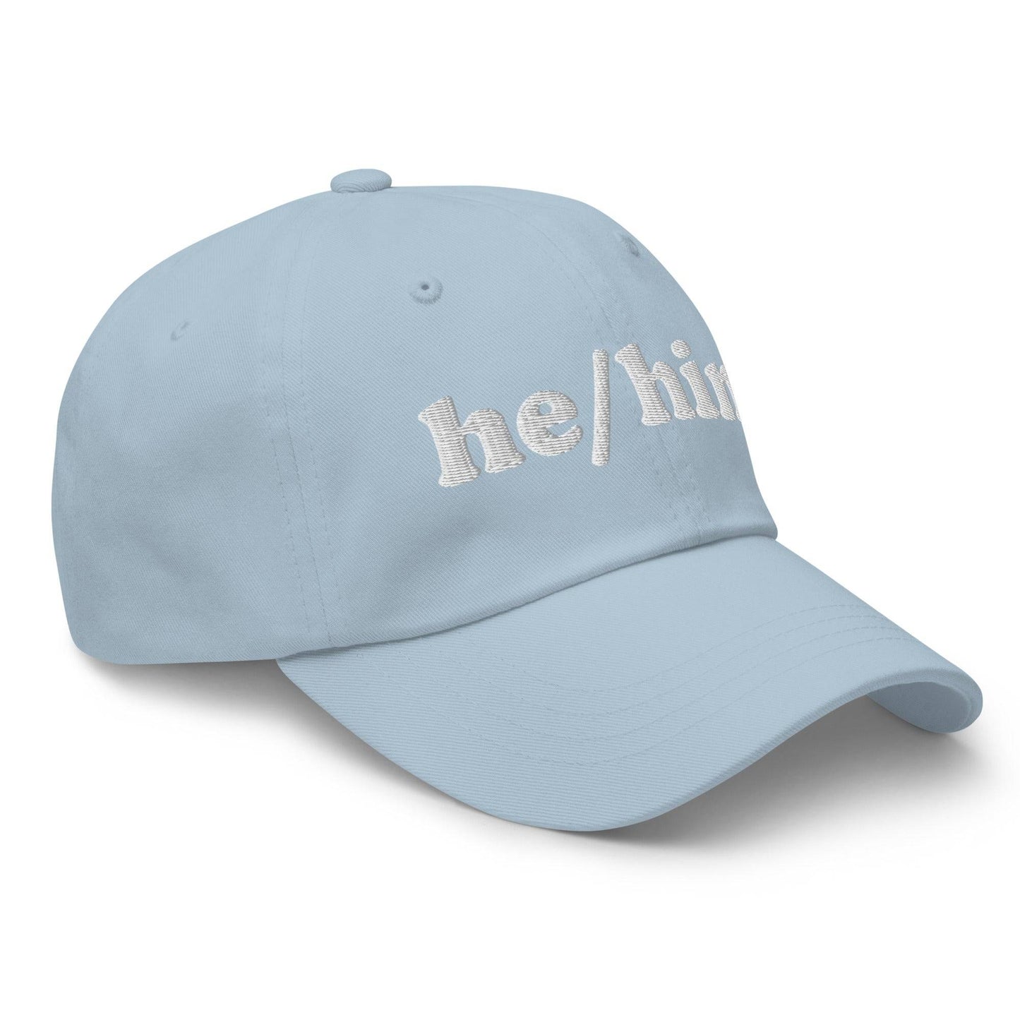 Introducing the He/Him Cap by Pridelity: A stylish black cap featuring "he/him" embroidered in white on the front. It adds a subtle yet meaningful touch to pride outfits while celebrating identity with simplicity and elegance.