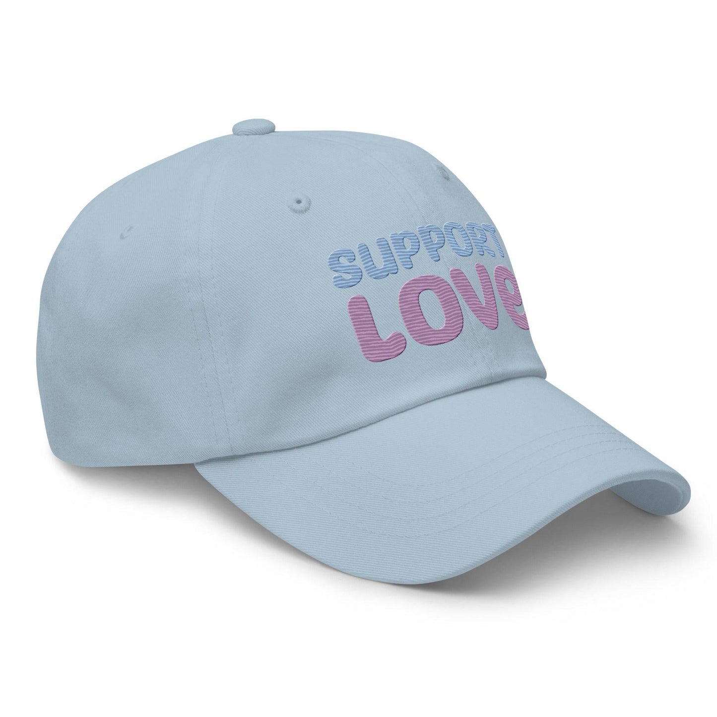 Discover the "Support Love Cap" by Pridelity, a black cap ideal for pride outfits, featuring the phrase "Support Love" embroidered on the front in light blue and pink letters.