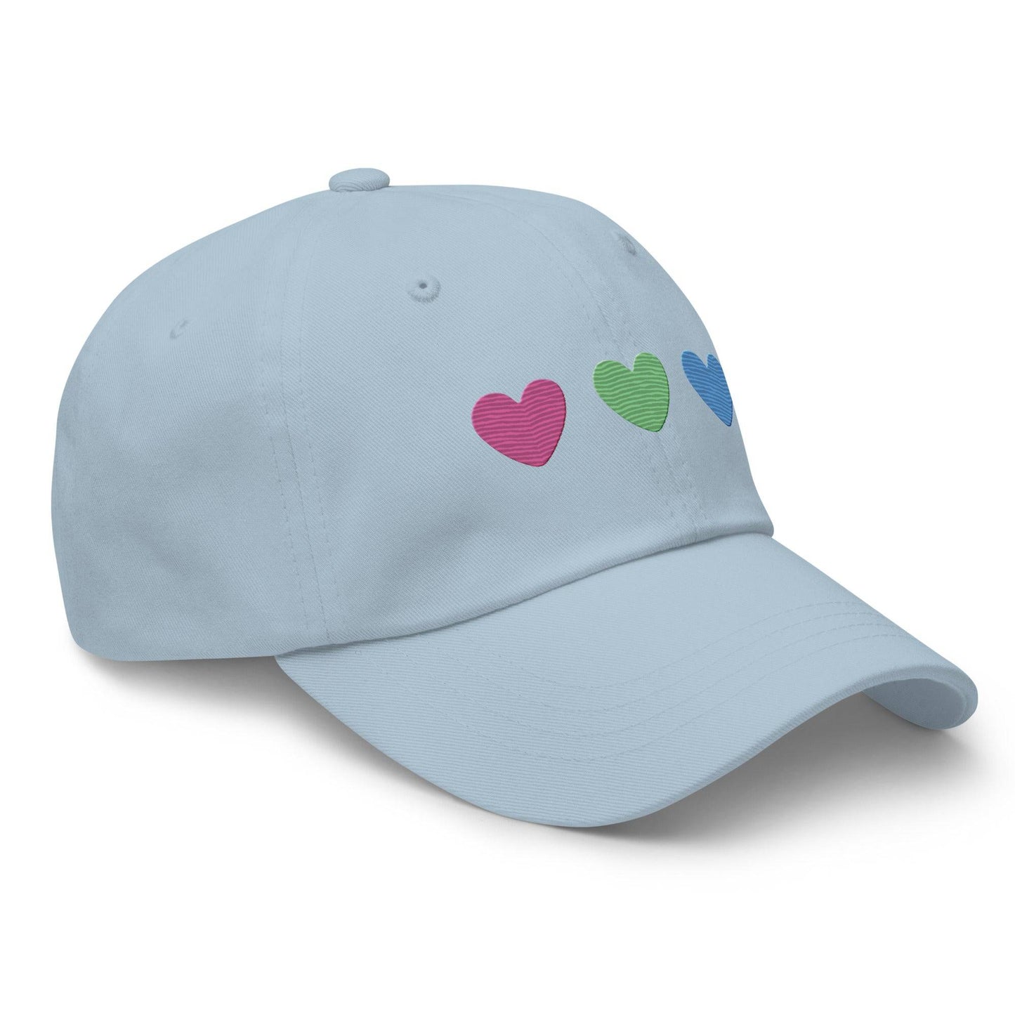 The Polysexual Hearts Cap by Pridelity is a black baseball cap ideal for pride outfits, featuring three embroidered hearts in pink, green, and blue arranged in a row on the front.