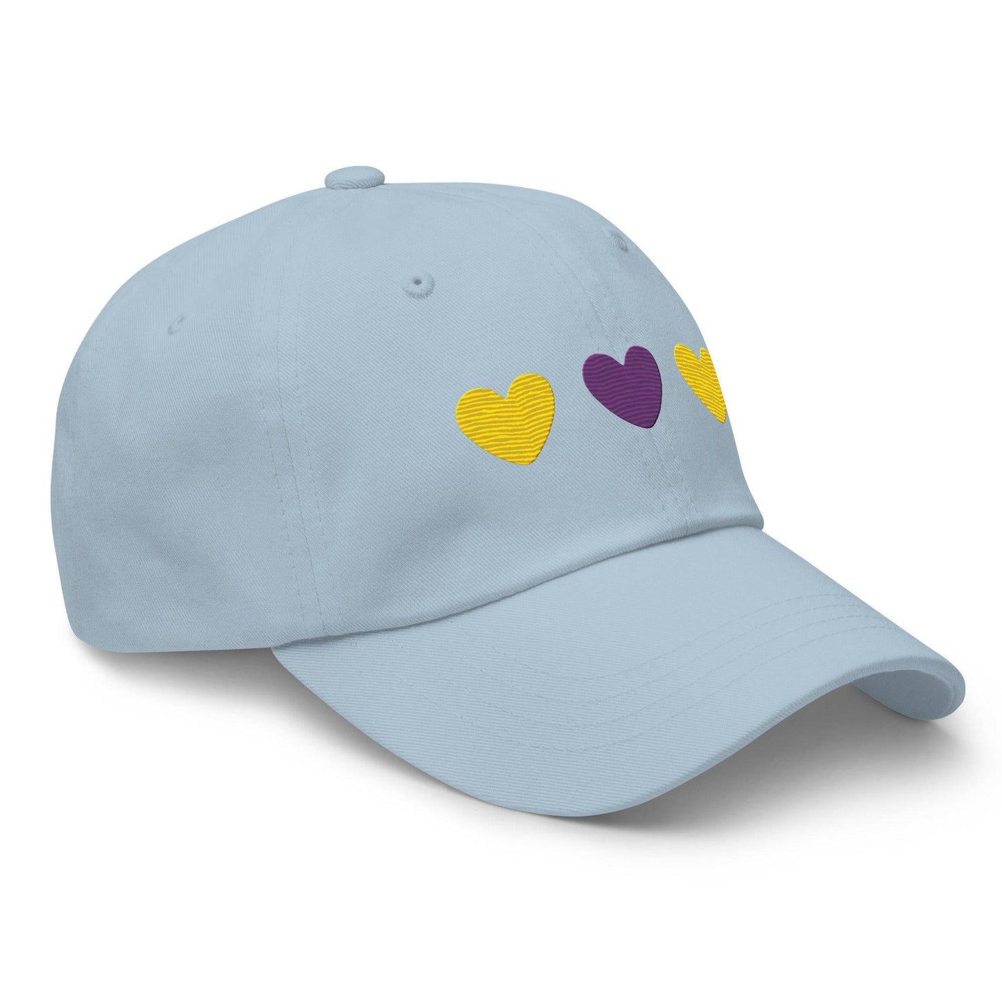 Introducing the Intersex Hearts Cap by Pridelity, a stylish black baseball cap ideal for pride outfits. It features three embroidered hearts, with two yellow ones on the sides and a purple heart prominently in the center.