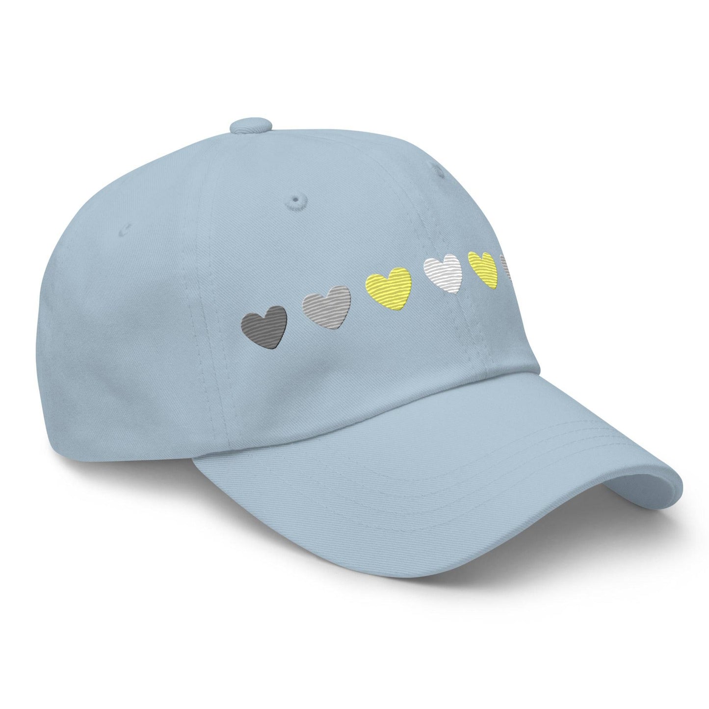 Introducing the Demigender Hearts Cap by Pridelity, a stylish black baseball cap ideal for pride outfits. It features a row of hearts embroidered on the front, transitioning seamlessly from gray on the left to vibrant yellow in the center, and back to gray on the right.