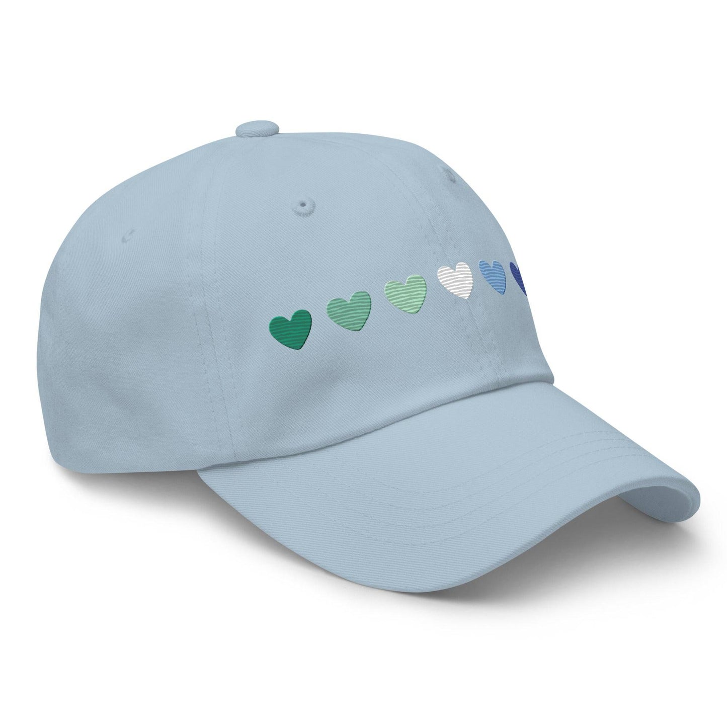 The Gay Men Hearts Cap by Pridelity is a black cap adorned with a row of seven hearts in gradient colors from green to blue, making it an ideal accessory for adding a subtle yet vibrant touch to pride outfits.