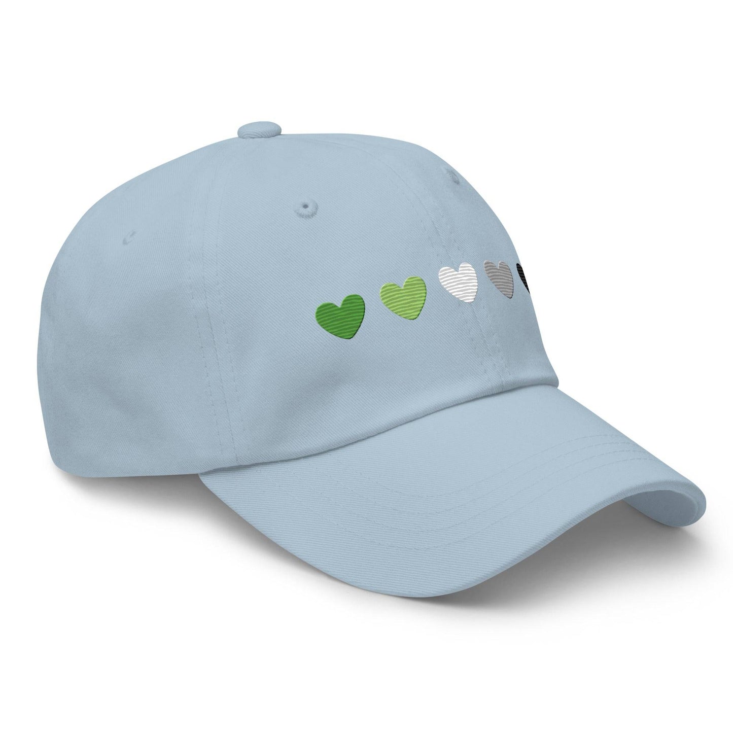 The Aromantic Hearts Cap by Pridelity, part of the Pride Collection, is a beige baseball cap featuring five hearts in a row colored dark green, light green, white, gray, and black to represent the aromantic pride flag.