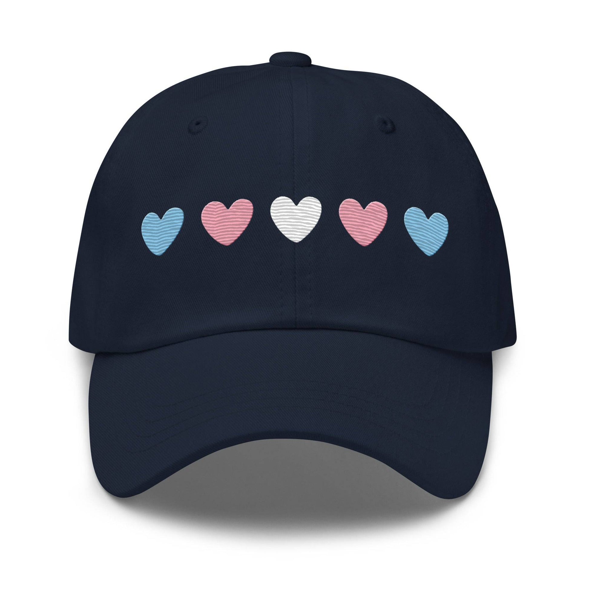 Introducing the "Trans Hearts Cap" from Pridelity, a black baseball cap adorned with embroidered pastel heart designs in pink, white, and blue on the front, making it an ideal accessory to enhance your pride outfits.