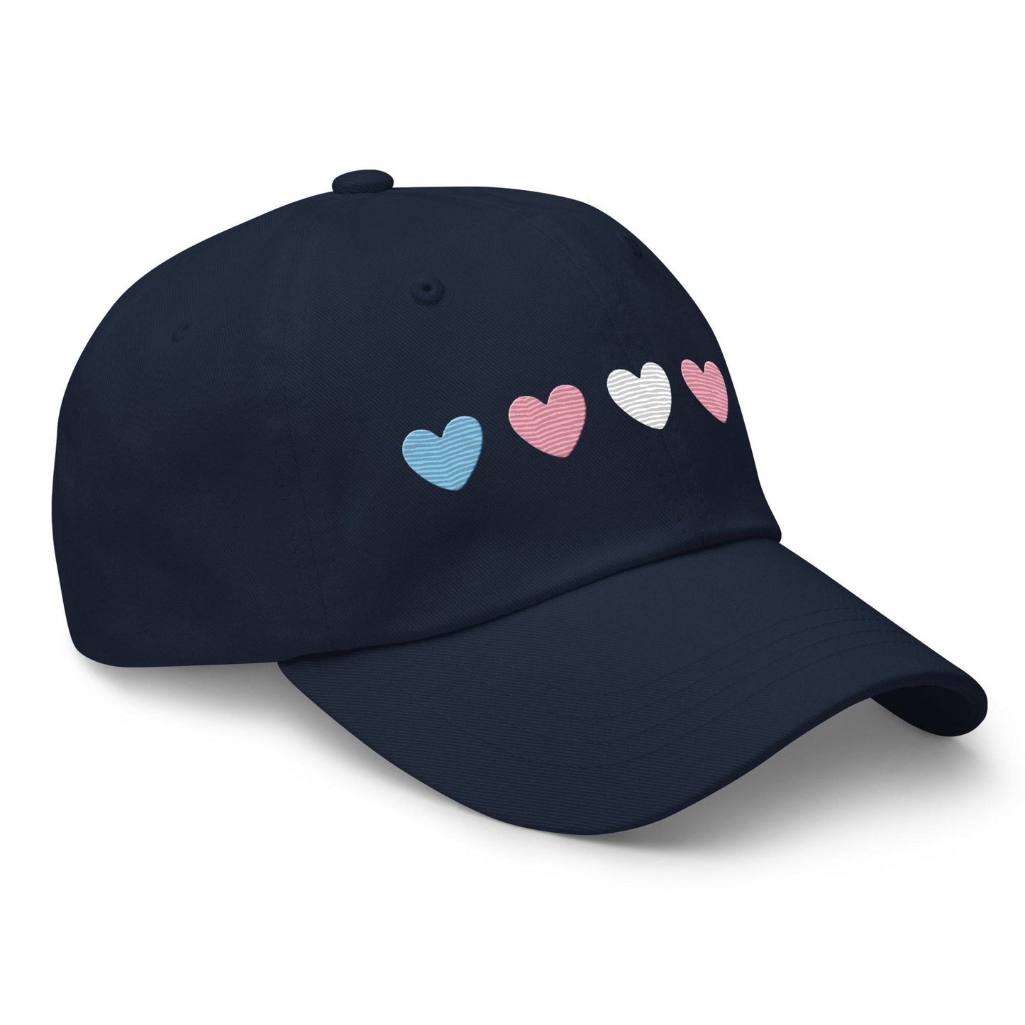 Introducing the "Trans Hearts Cap" from Pridelity, a black baseball cap adorned with embroidered pastel heart designs in pink, white, and blue on the front, making it an ideal accessory to enhance your pride outfits.