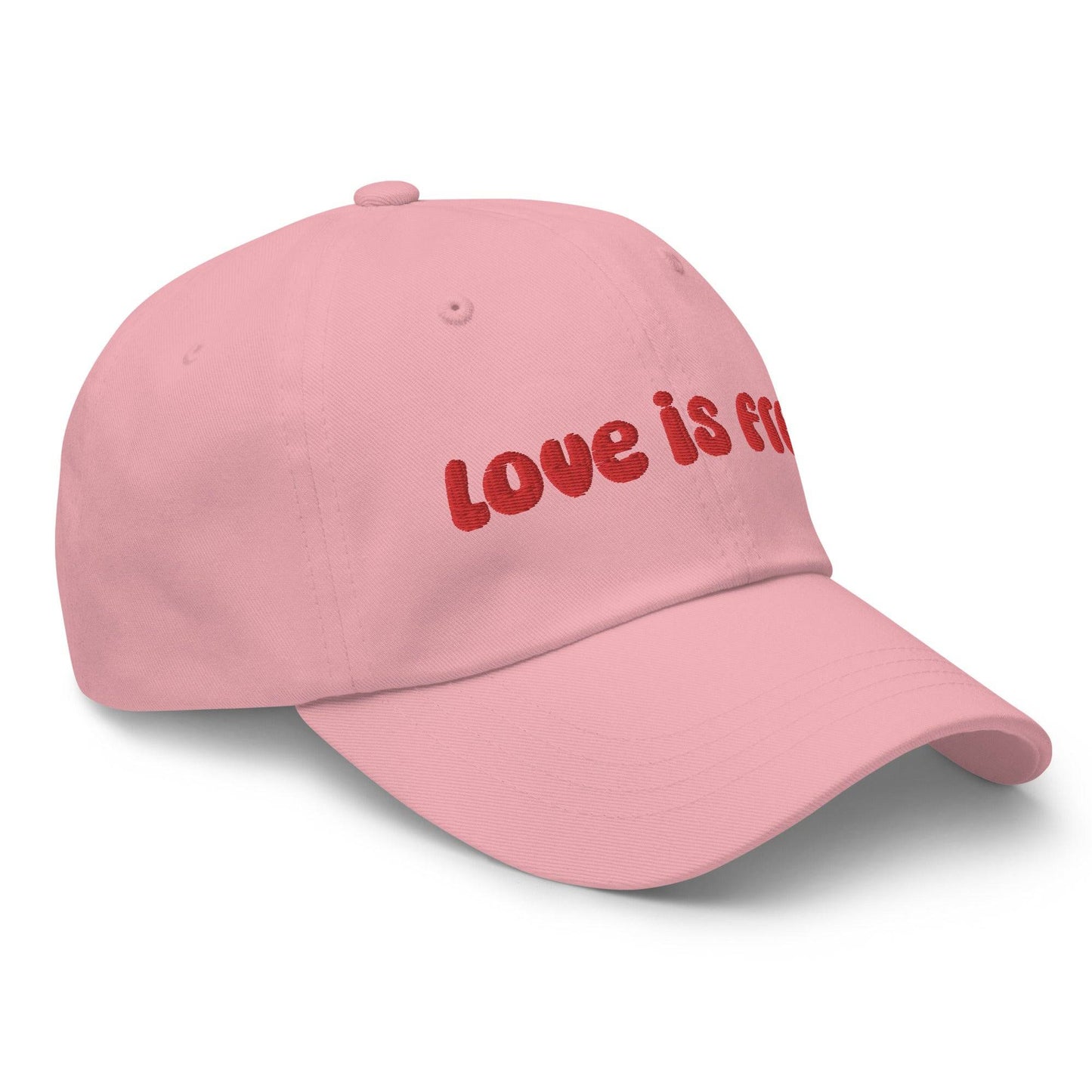 The Pridelity Love Is Free Cap, in a striking white color, is an ideal addition to pride outfits. It boasts the phrase "love is free" beautifully embroidered in bold red lettering on the front.