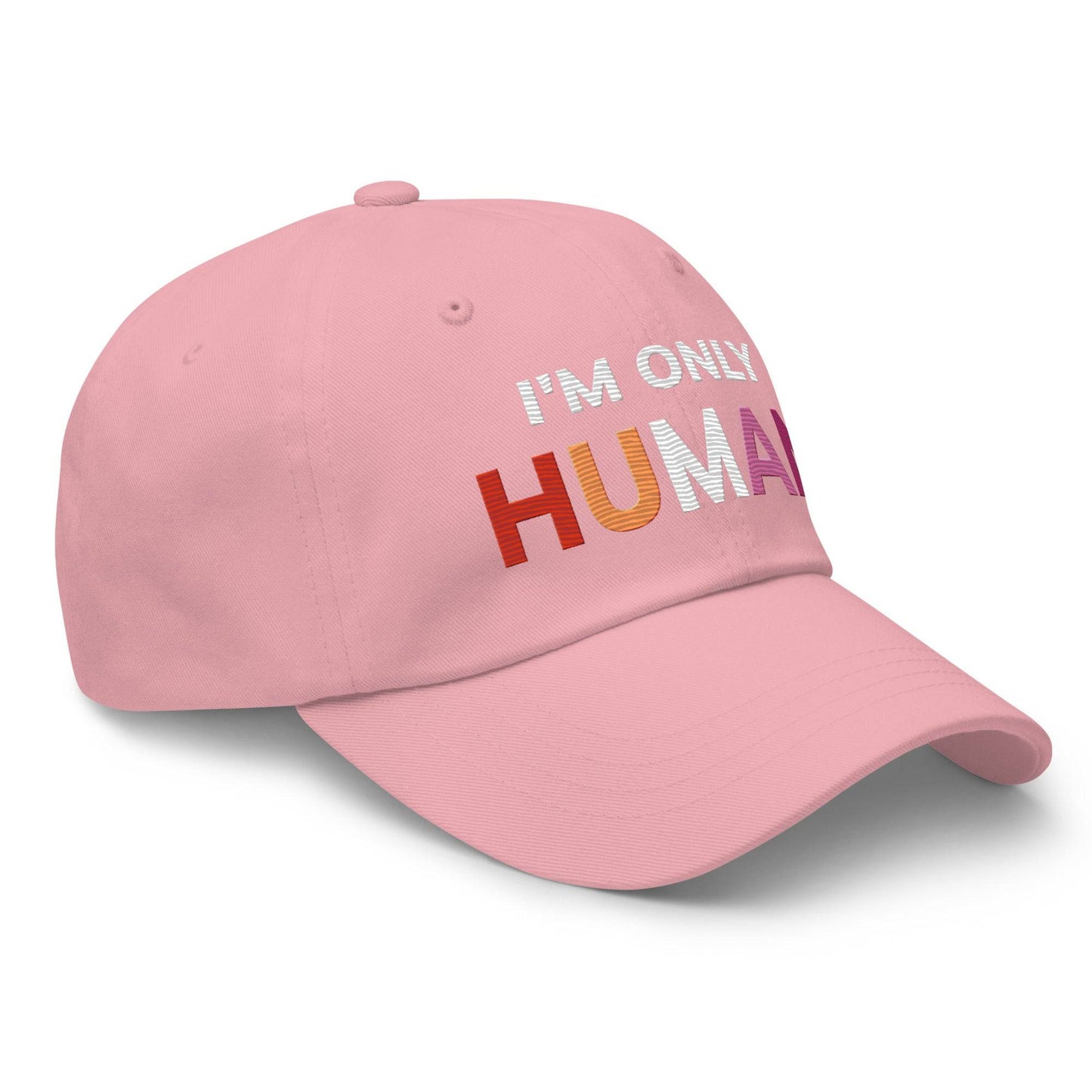 The Pridelity "I'm Only Human Cap" is a black baseball cap ideal for pride outfits, prominently displaying the phrase "I'M ONLY HUMAN" on the front, with "HUMAN" in bold, colorful letters transitioning from orange to pink.