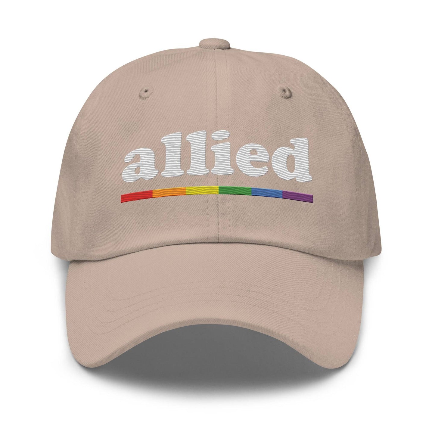 A Pridelity Allied Cap featuring "allied" embroidered in white above a vibrant, Pride-inspired rainbow line.