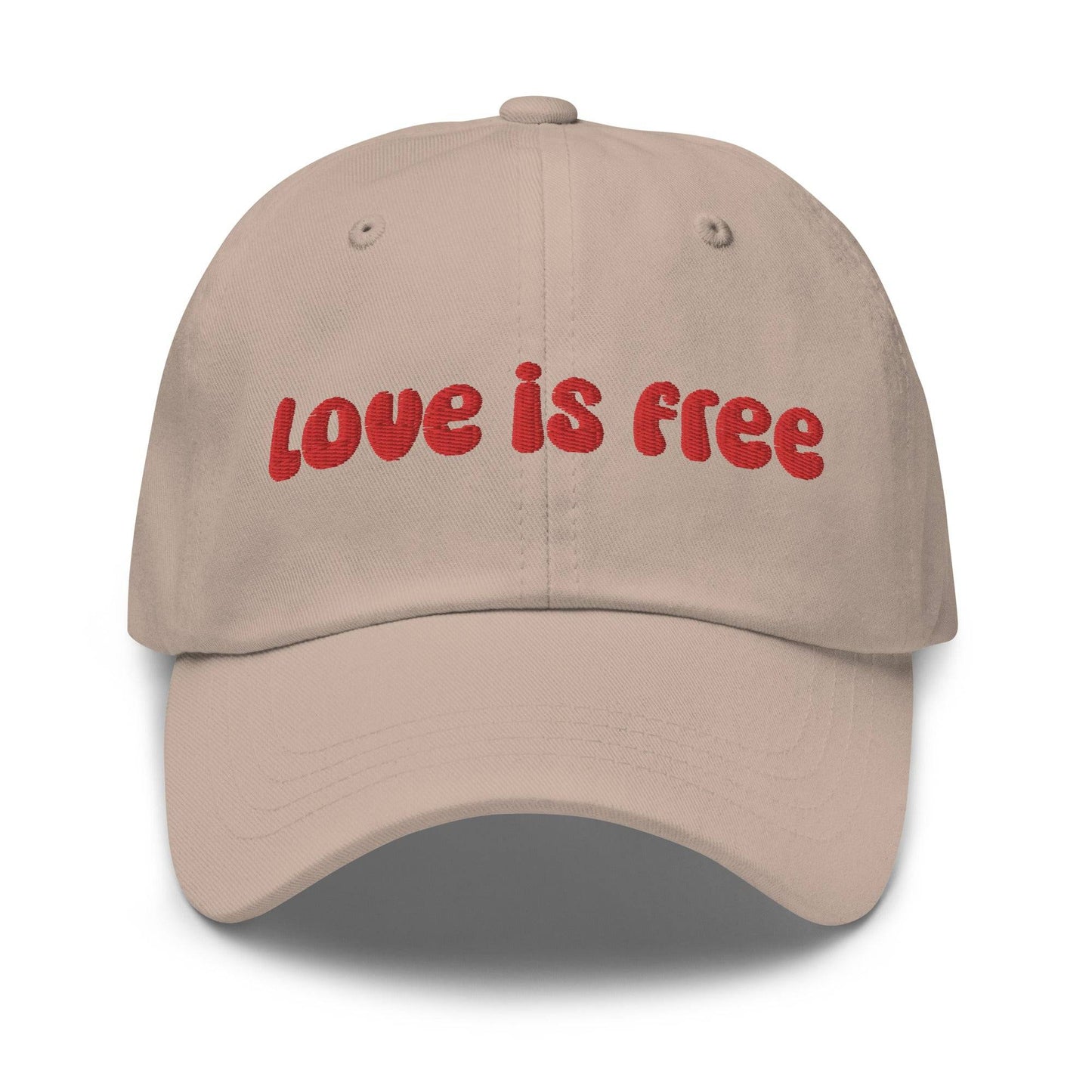 The Pridelity Love Is Free Cap, in a striking white color, is an ideal addition to pride outfits. It boasts the phrase "love is free" beautifully embroidered in bold red lettering on the front.