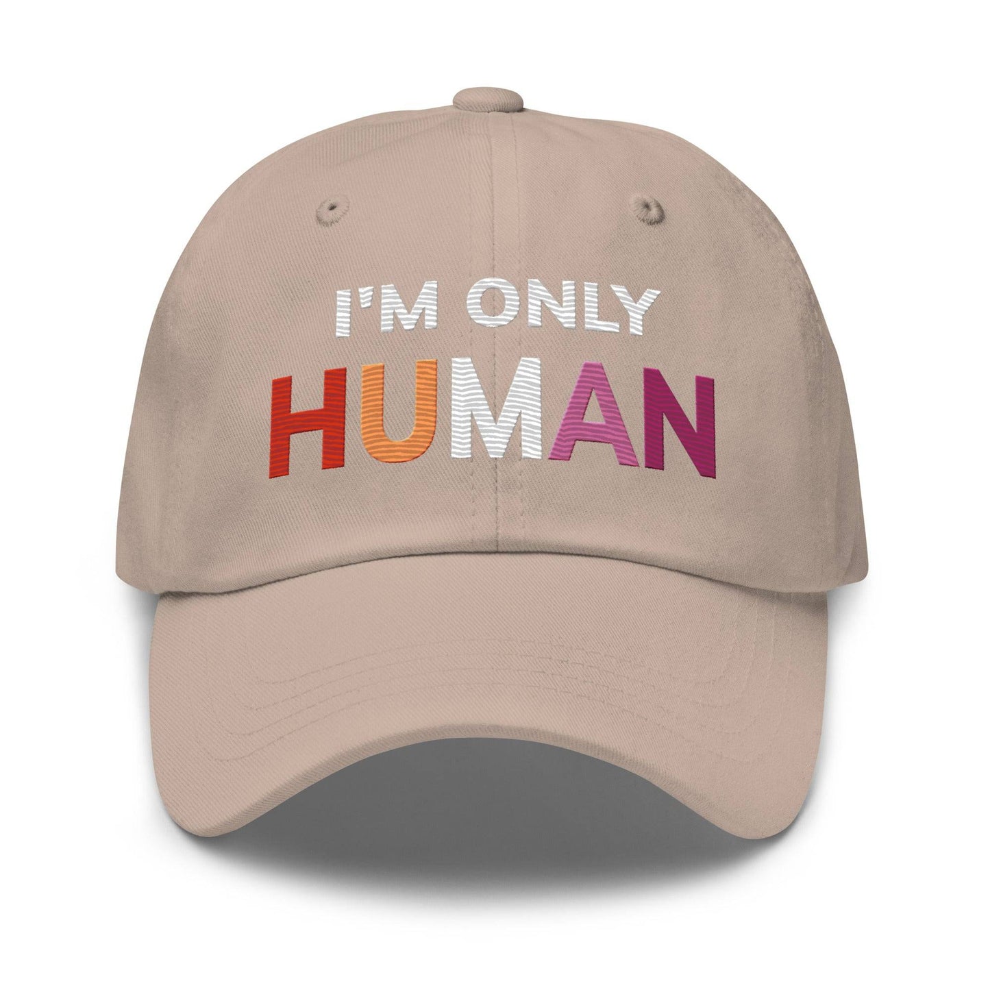 The Pridelity "I'm Only Human Cap" is a black baseball cap ideal for pride outfits, prominently displaying the phrase "I'M ONLY HUMAN" on the front, with "HUMAN" in bold, colorful letters transitioning from orange to pink.