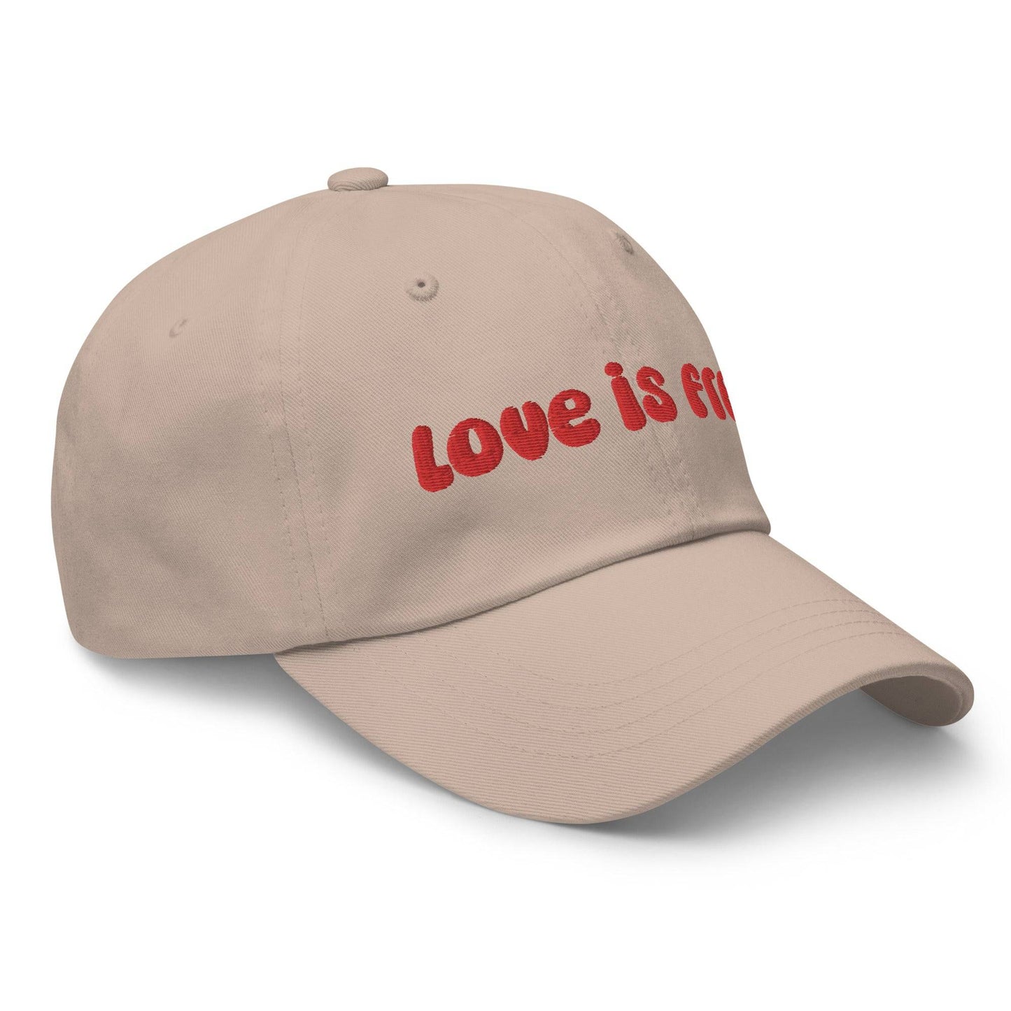 The Pridelity Love Is Free Cap, in a striking white color, is an ideal addition to pride outfits. It boasts the phrase "love is free" beautifully embroidered in bold red lettering on the front.