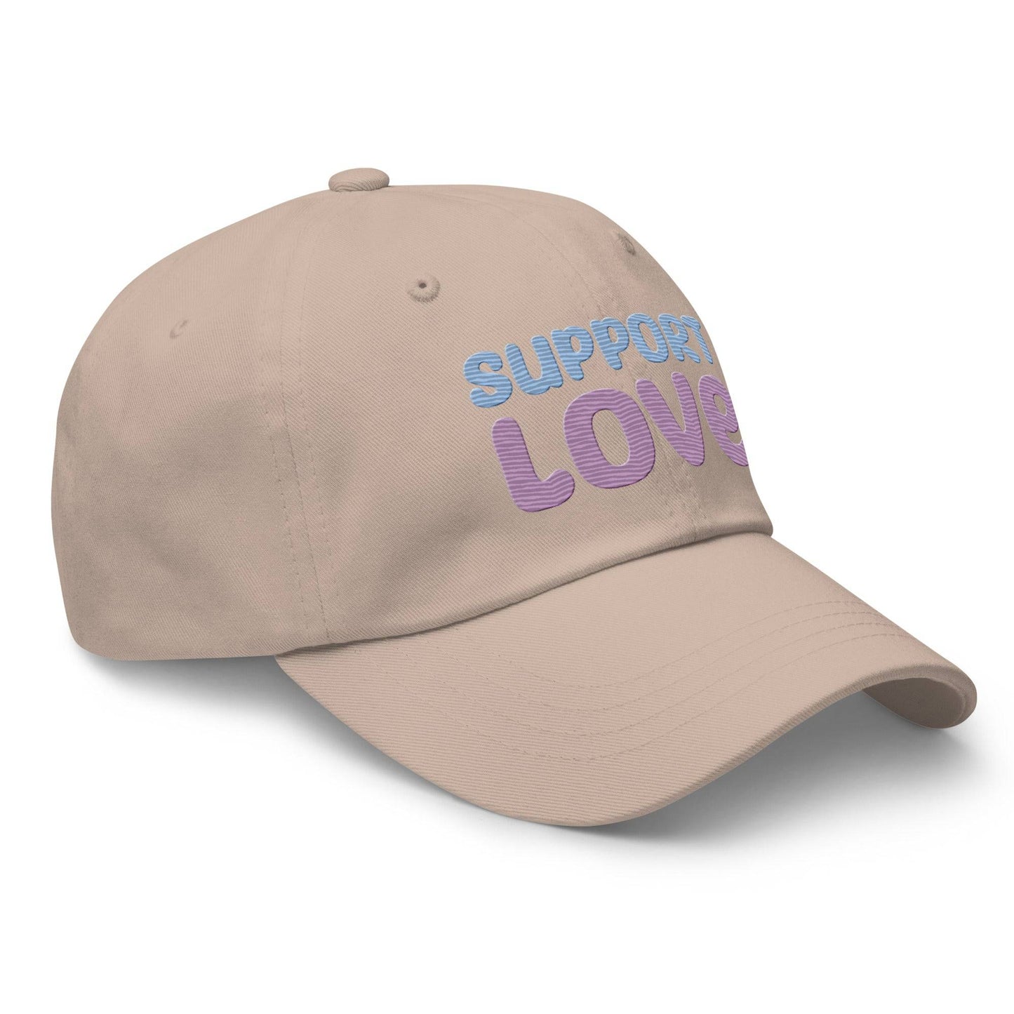 Discover the "Support Love Cap" by Pridelity, a black cap ideal for pride outfits, featuring the phrase "Support Love" embroidered on the front in light blue and pink letters.