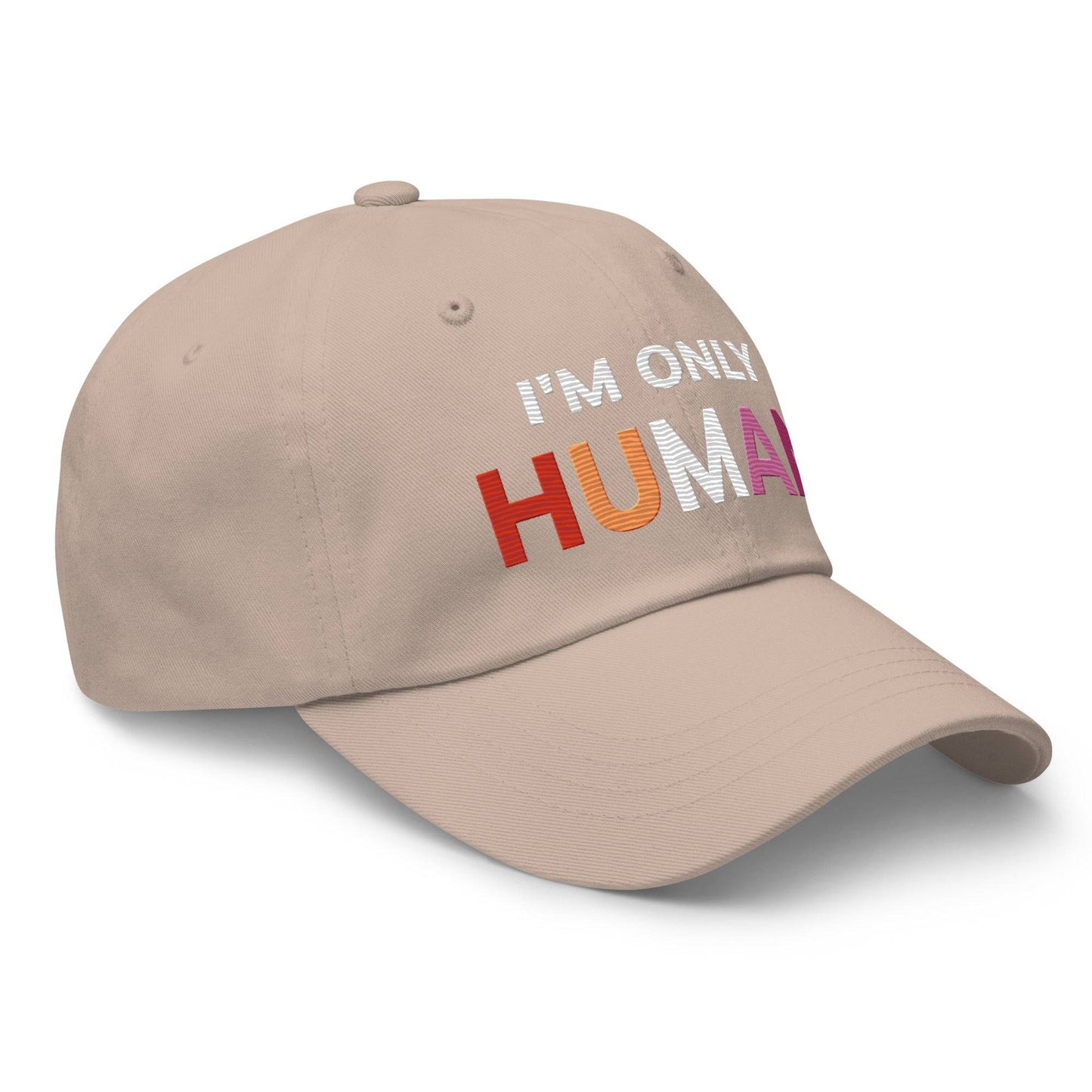 The Pridelity "I'm Only Human Cap" is a black baseball cap ideal for pride outfits, prominently displaying the phrase "I'M ONLY HUMAN" on the front, with "HUMAN" in bold, colorful letters transitioning from orange to pink.