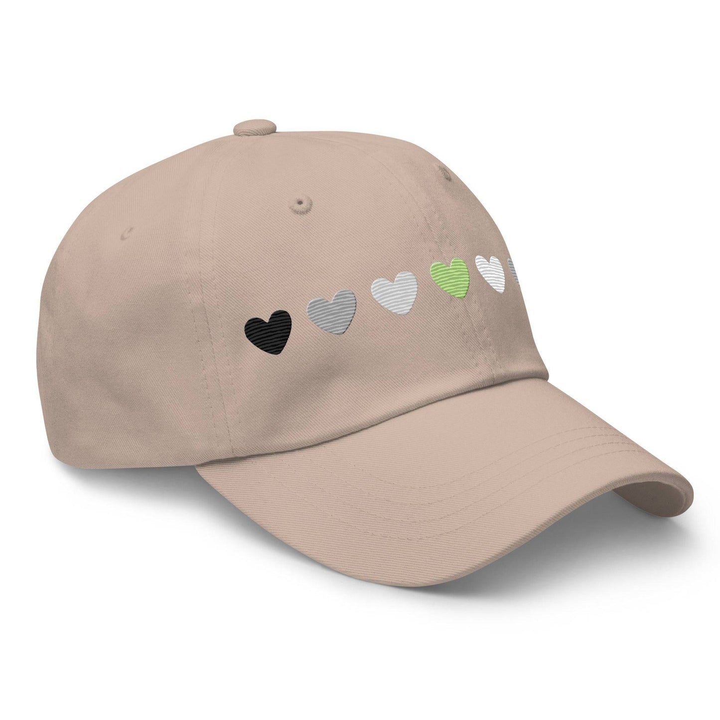 Introducing the Agender Hearts Cap by Pridelity: a pink baseball cap made from Chino cotton twill, showcasing a row of seven heart shapes in the aromantic flag colors—dark green, light green, white, gray, and black. It’s a classic hat featuring a vintage buckle for adjustable comfort.