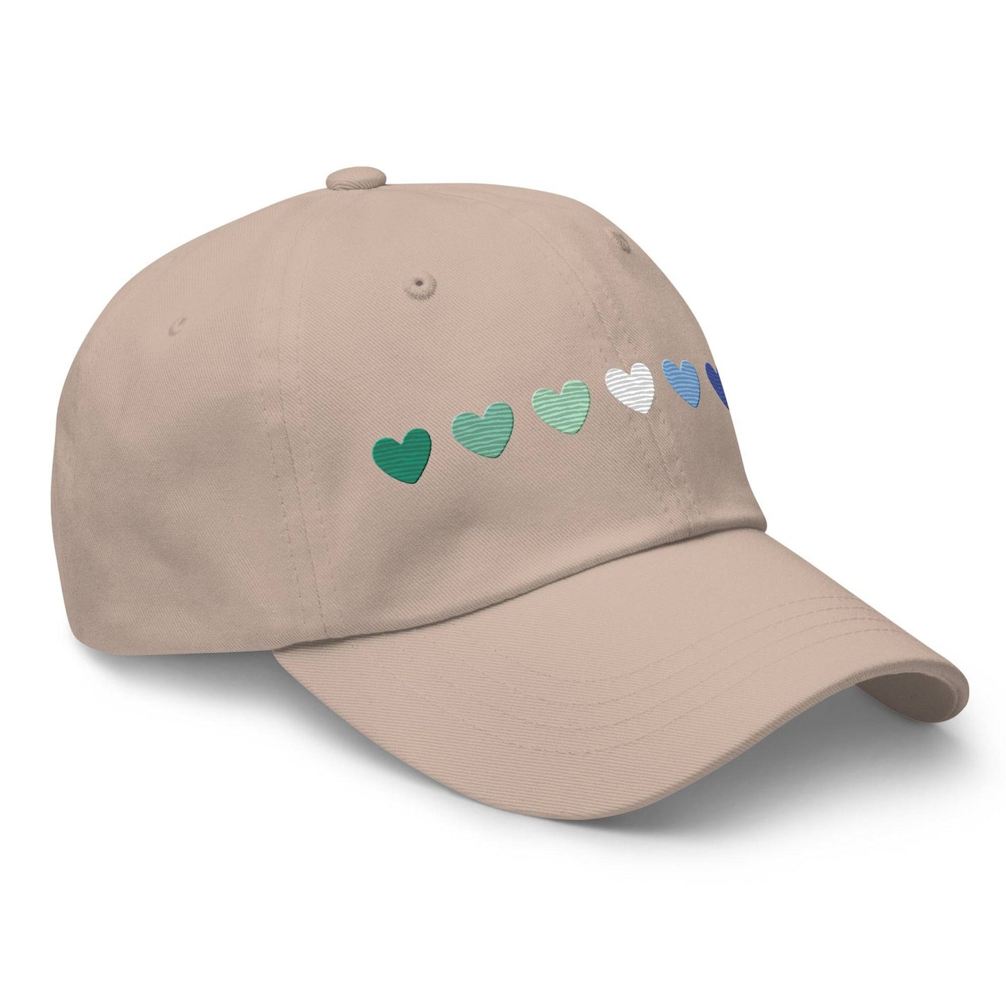 The Gay Men Hearts Cap by Pridelity is a black cap adorned with a row of seven hearts in gradient colors from green to blue, making it an ideal accessory for adding a subtle yet vibrant touch to pride outfits.