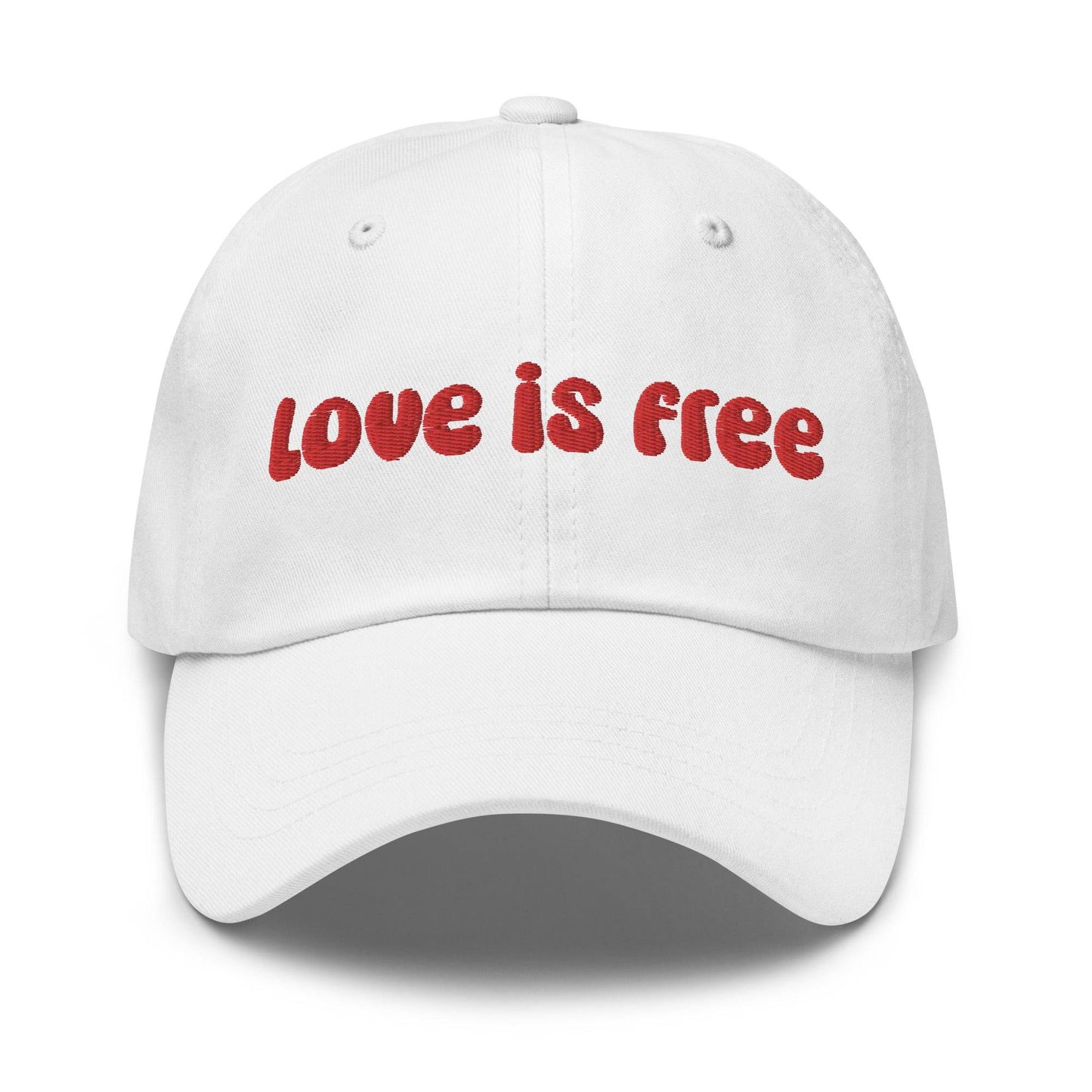 The Pridelity Love Is Free Cap, in a striking white color, is an ideal addition to pride outfits. It boasts the phrase "love is free" beautifully embroidered in bold red lettering on the front.