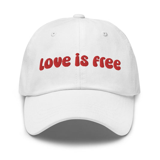 The Pridelity Love Is Free Cap, in a striking white color, is an ideal addition to pride outfits. It boasts the phrase "love is free" beautifully embroidered in bold red lettering on the front.