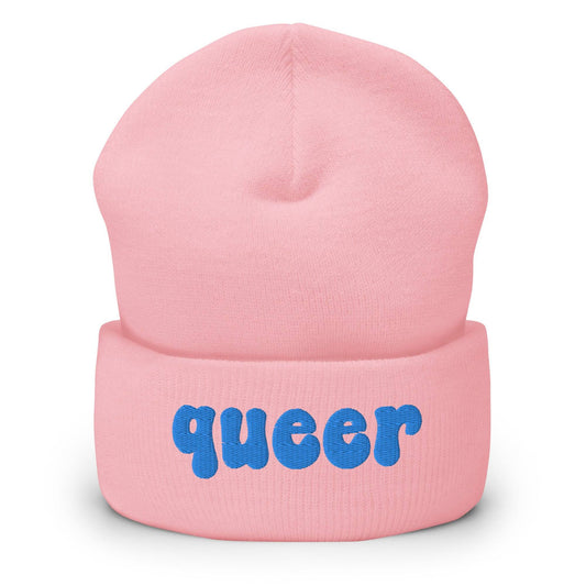 The Queer Beanie by Pridelity, in a delightful baby pink with the word "queer" emblazoned in playful blue bold letters on the front, is a standout piece of gay clothing.