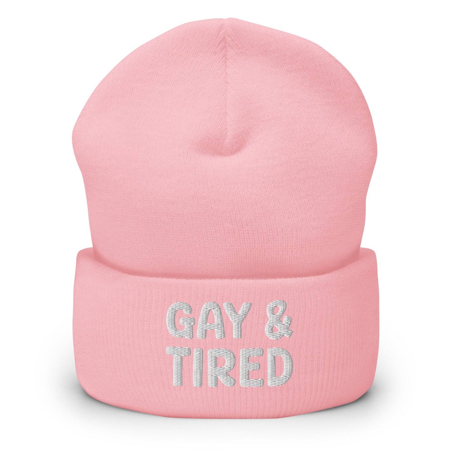 The Gay & Tired Beanie by Pridelity is a stylish accessory for showcasing your individuality, featuring white embroidered text on a black background that boldly states "GAY & TIRED" across the front. Its folded bottom ensures the message is prominently displayed.
