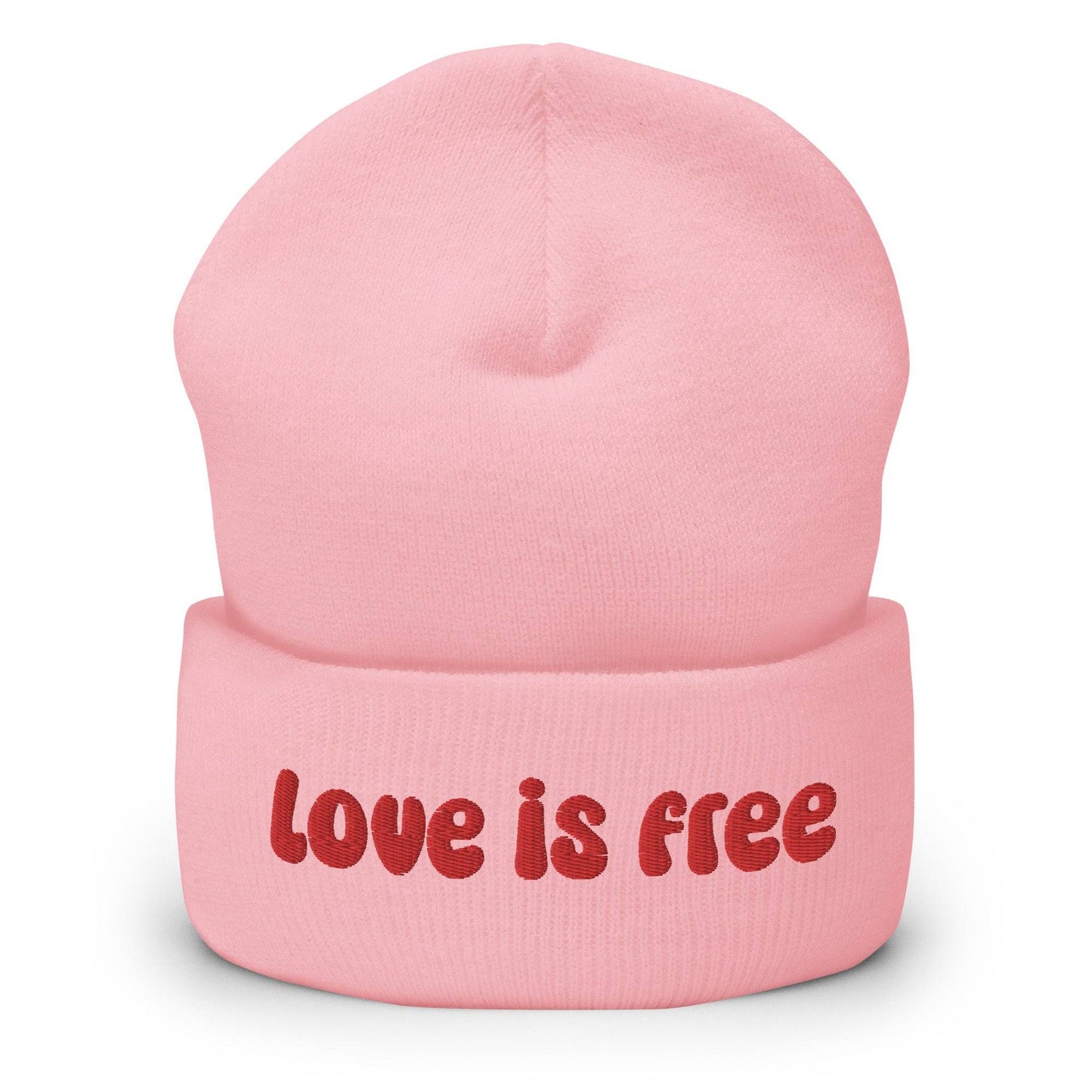 The Love Is Free Beanie by Pridelity is a baby pink accessory that boldly features the phrase "Love is free" in red on the front cuff, making it a perfect and stylish addition to any gay clothing collection for those embracing their authentic selves.