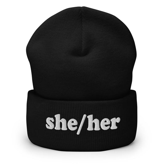 The She/Her Beanie by Pridelity, ideal for those seeking gay clothing options, is a heather grey knit beanie with the pronouns "she/her" beautifully embroidered in white on the front.