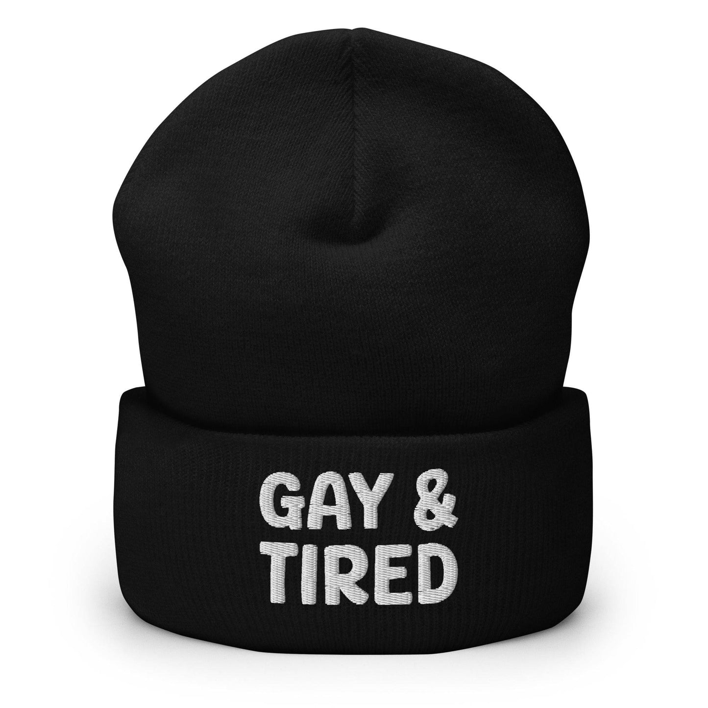 The Gay & Tired Beanie by Pridelity is a stylish accessory for showcasing your individuality, featuring white embroidered text on a black background that boldly states "GAY & TIRED" across the front. Its folded bottom ensures the message is prominently displayed.