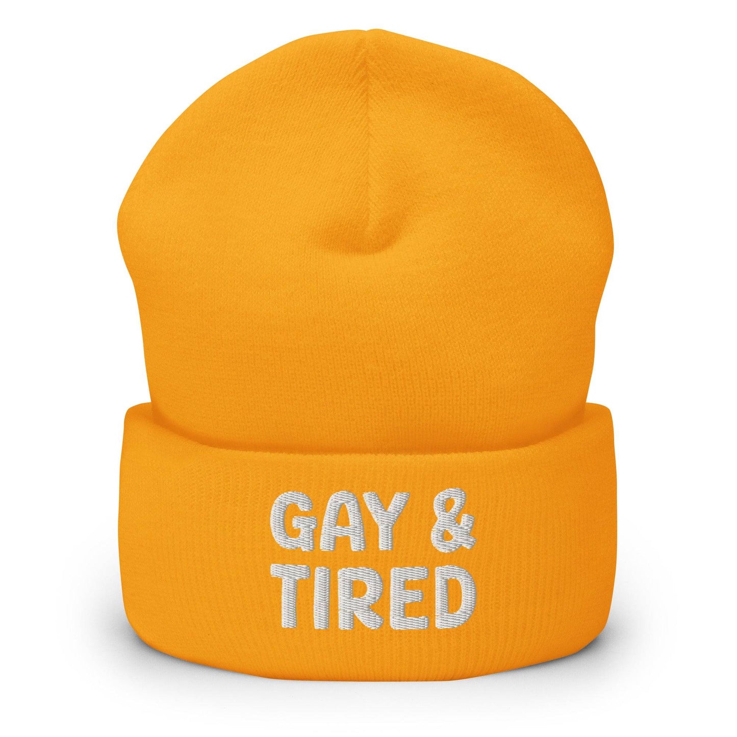 The Gay & Tired Beanie by Pridelity is a stylish accessory for showcasing your individuality, featuring white embroidered text on a black background that boldly states "GAY & TIRED" across the front. Its folded bottom ensures the message is prominently displayed.