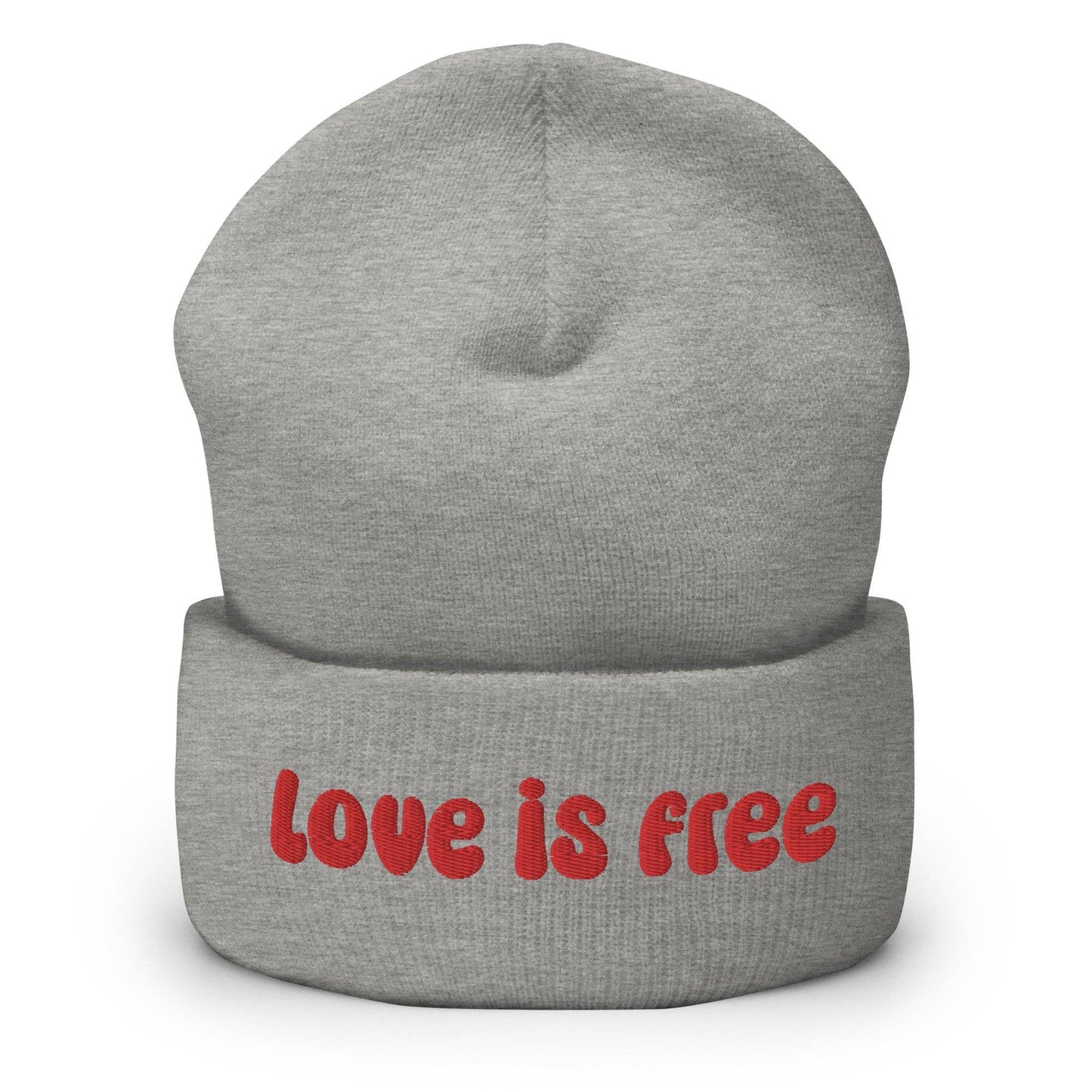 The Love Is Free Beanie by Pridelity is a baby pink accessory that boldly features the phrase "Love is free" in red on the front cuff, making it a perfect and stylish addition to any gay clothing collection for those embracing their authentic selves.