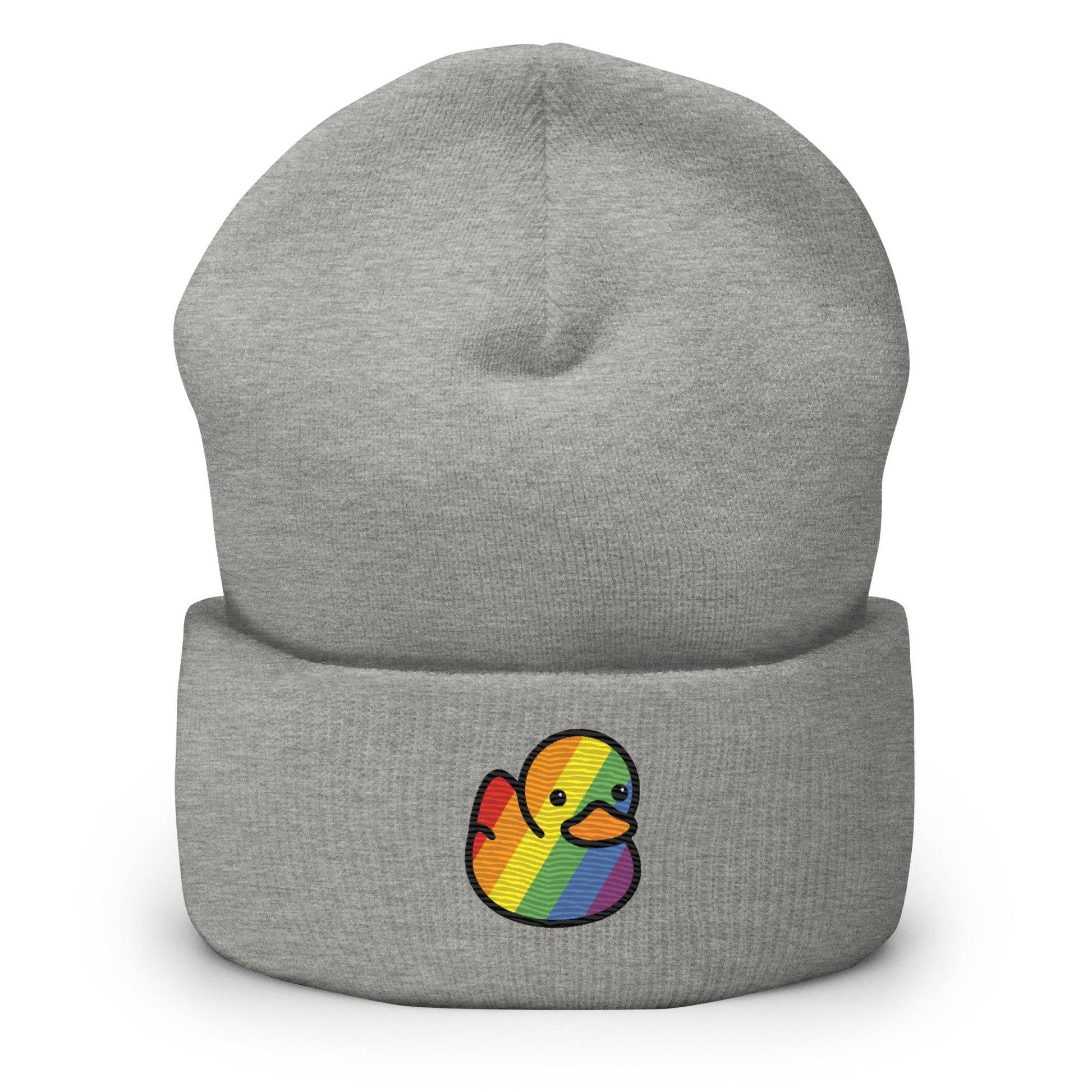 The Pride Duck Beanie by Pridelity, a striking piece of gay clothing, showcases an embroidered rubber duck with a rainbow pattern on its body, located on the cuff. This gold beanie features a folded brim and a rounded top.