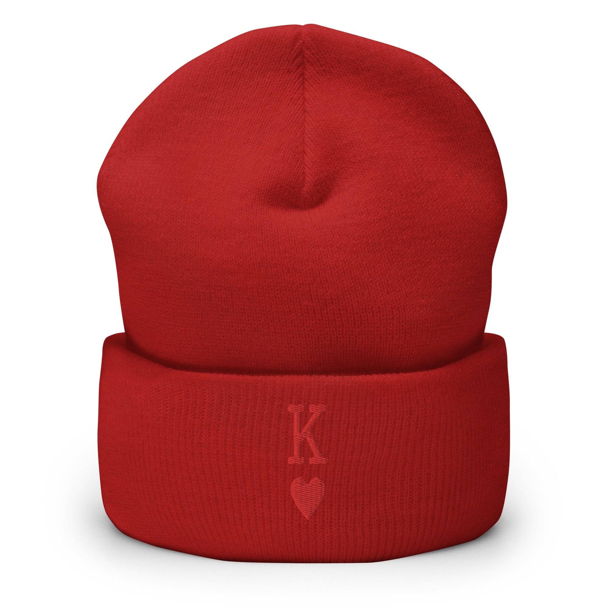 The King Beanie by Pridelity is a white beanie adorned with a red "K" and heart symbol on its folded edge, perfect for individuals expressing their identity through stylish gay clothing.