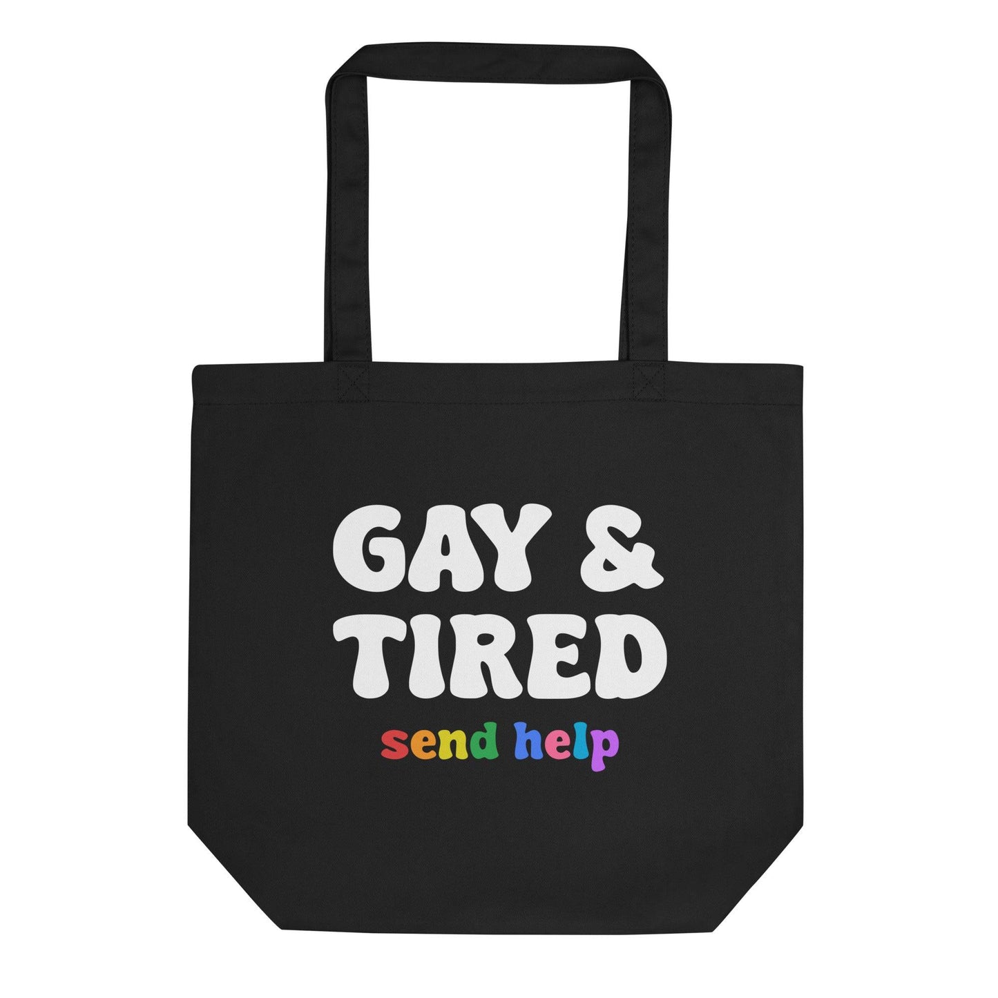 A black tote bag from Pridelity, known as the Gay & Tired Tote Bag, prominently displays "GAY & TIRED" in bold white letters. Below, "send help" is highlighted in vibrant rainbow colors, capturing the lively essence of a Rainbow Store item.