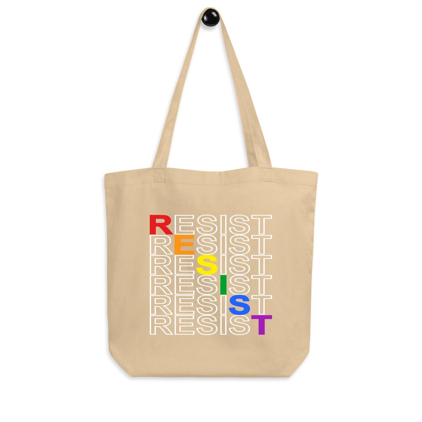 This black Resist Tote Bag by Pridelity, available at Rainbow Store, showcases the word "RESIST" repeated five times in vibrant rainbow colors: red, orange, yellow, green, and purple.