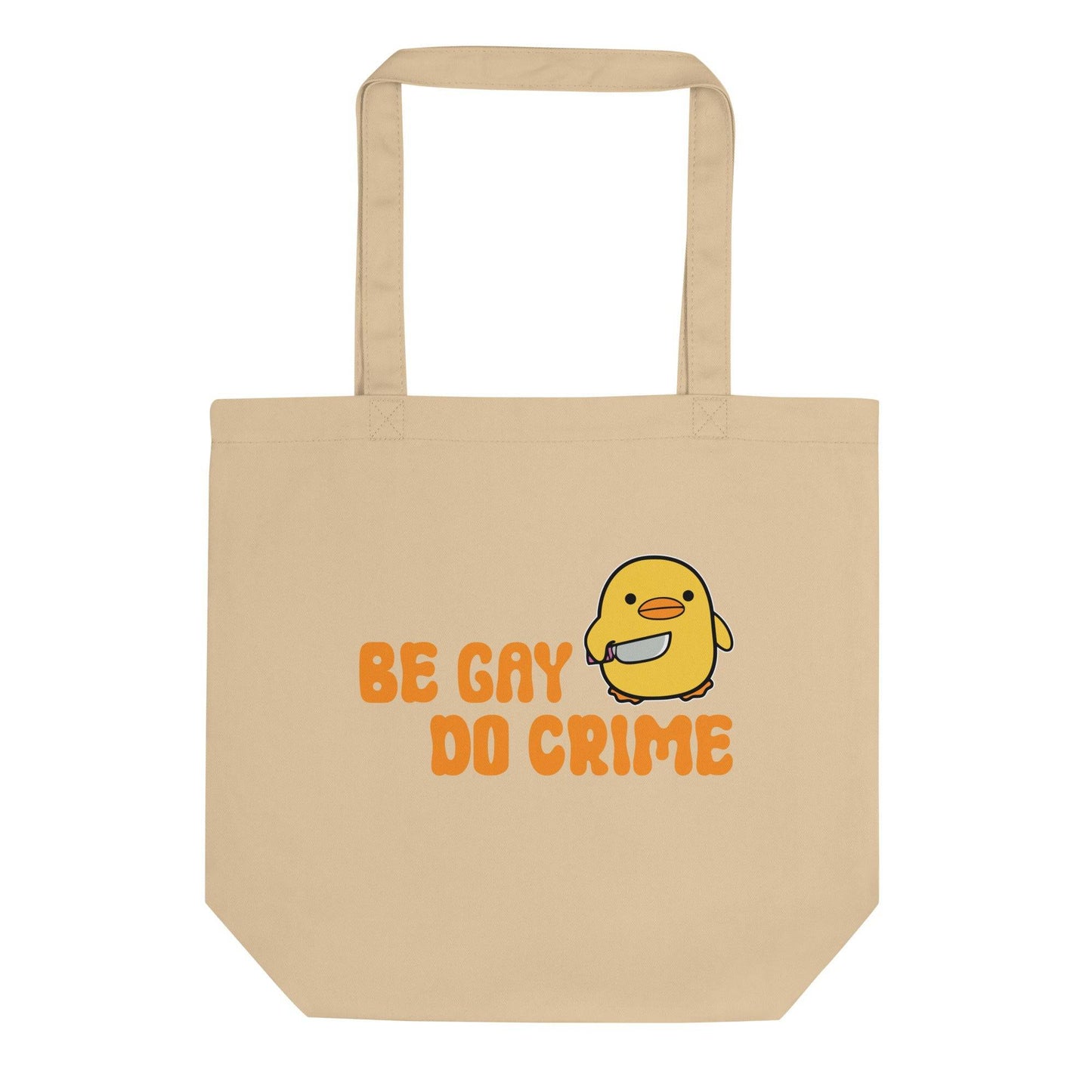 The "Be Gay Do Crime" Tote Bag from Pridelity's Pride Collection features a cute yellow bird illustration holding a white object. With the bold message "Be Gay Do Crime" printed in striking orange letters, this black tote bag makes a fearless statement.