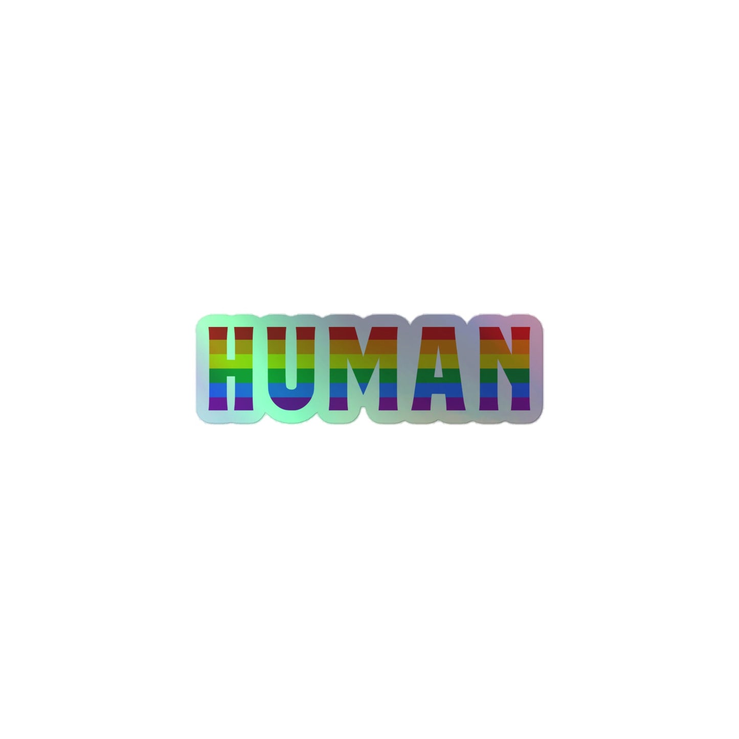 The image features the "Human Holo Sticker" by Pridelity, displaying bold letters spelling "HUMAN" filled with horizontal rainbow stripes, symbolizing LGBTQ+ pride against a pristine white background.