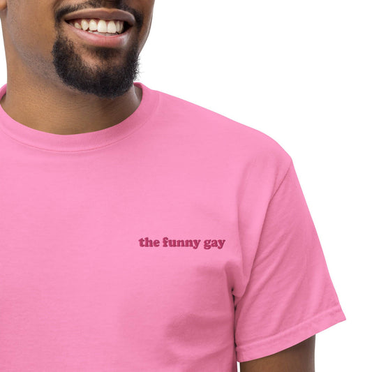 An azalea Pridelity T-shirt named "The Funny Gay" with the text printed in small, simple font on the front.